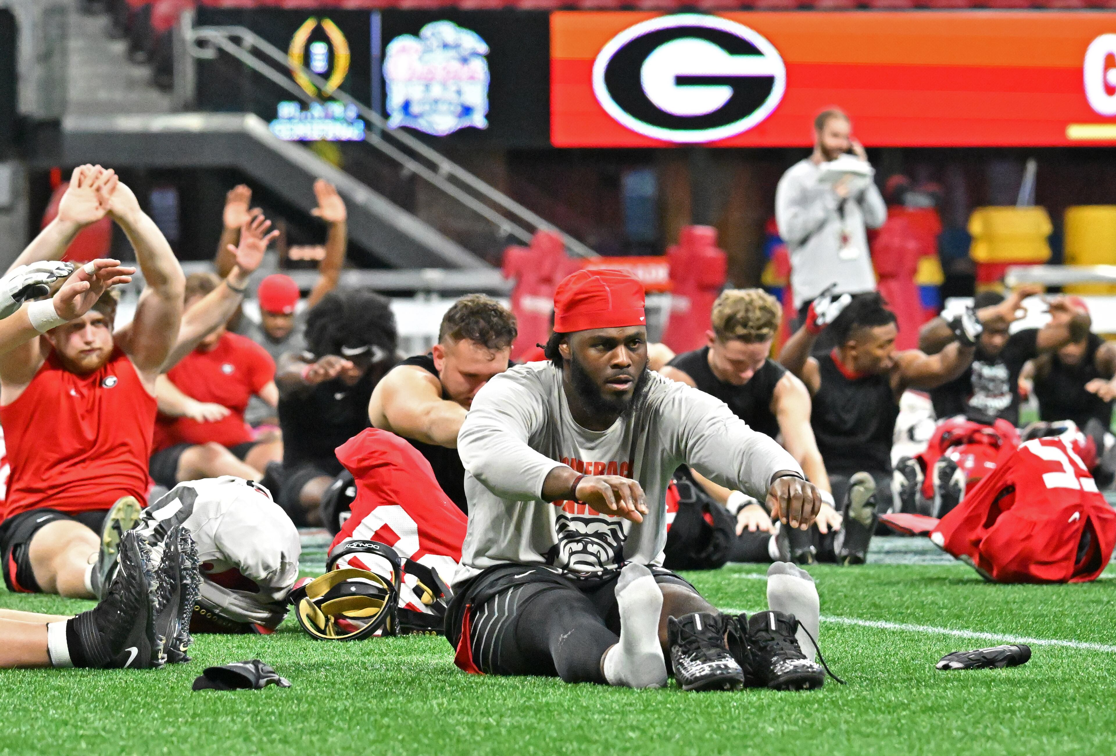Georgia players stretch during a practice session for the Chick-fil-A Peach Bowl game against Ohio State at the Mercedes-Benz Stadium on Thursday, Dec. 29, 2022, in Atlanta. (Hyosub Shin / Hyosub.Shin@ajc.com)