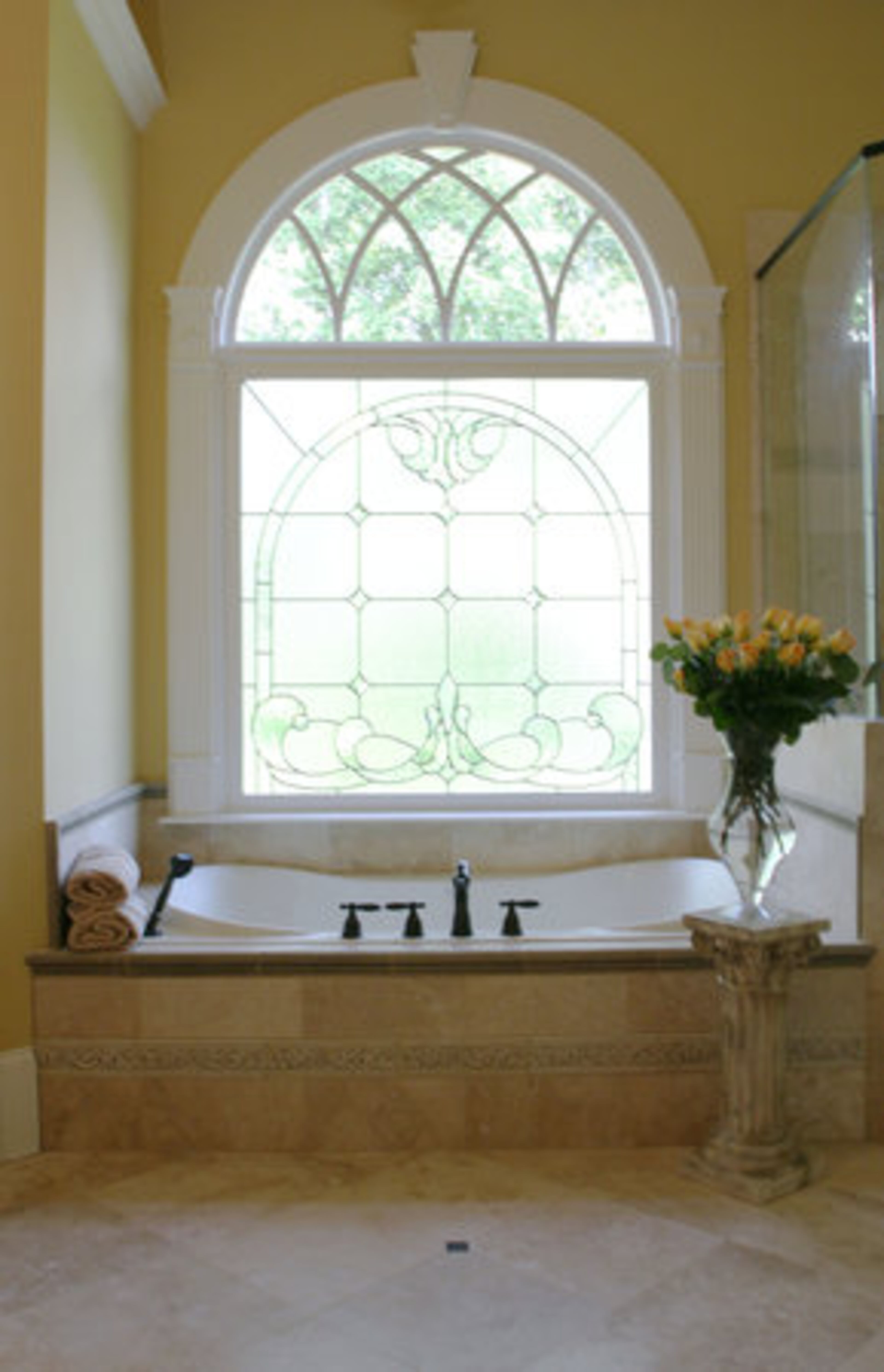 The master bath echoes the light, pastel color theme of the home.