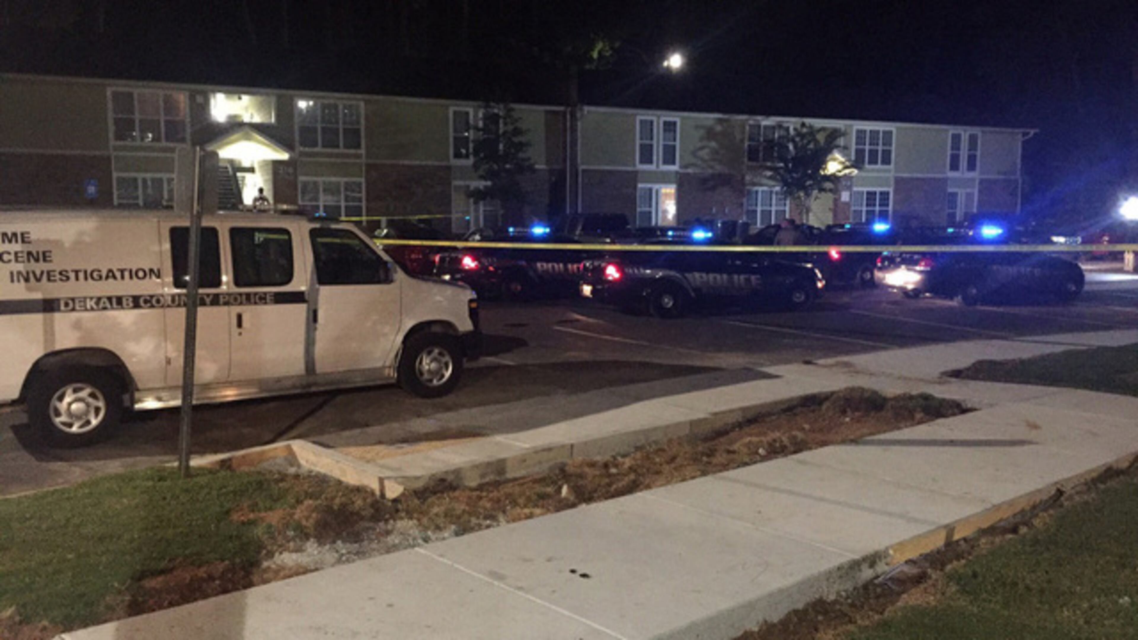 Police investigate a shooting that left one person dead and two critically injured Wednesday at the Oak Forest Apartments in DeKalb County. (Credit: Channel 2 Action News)