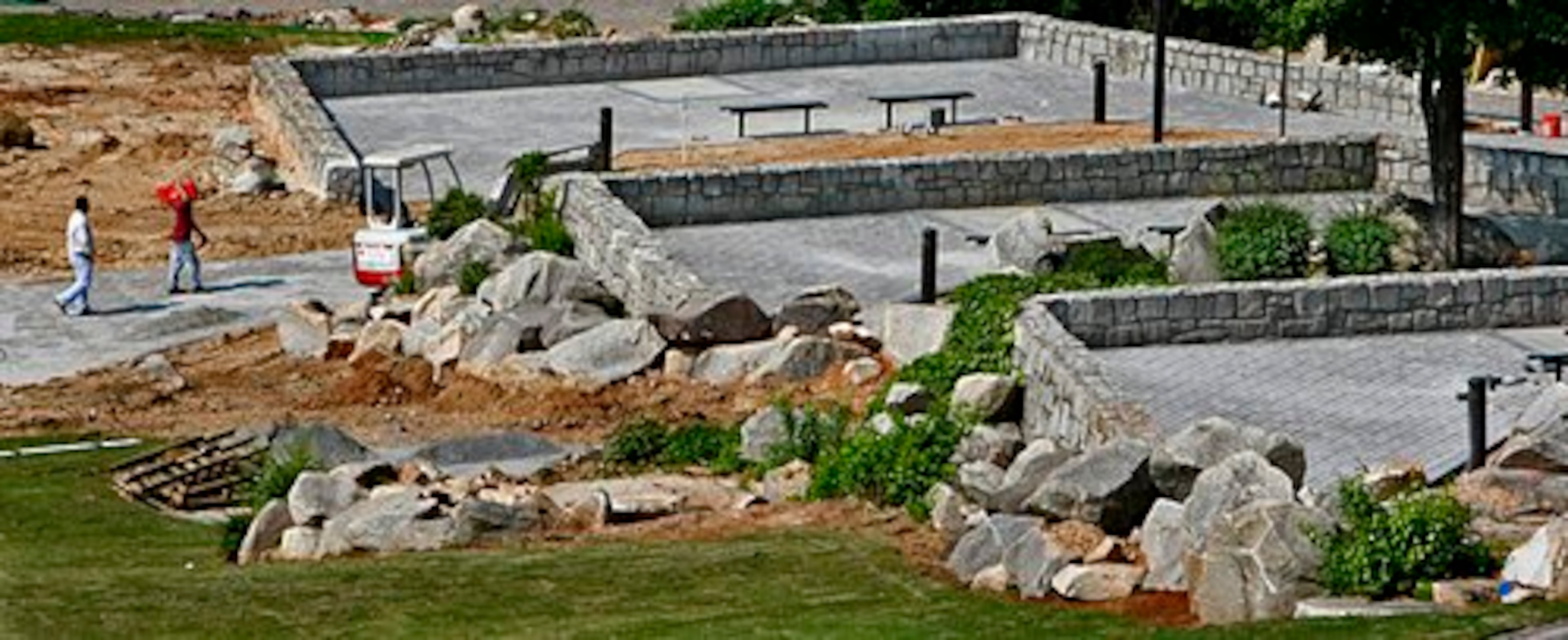 Workers move equipment into place on the new terraces.