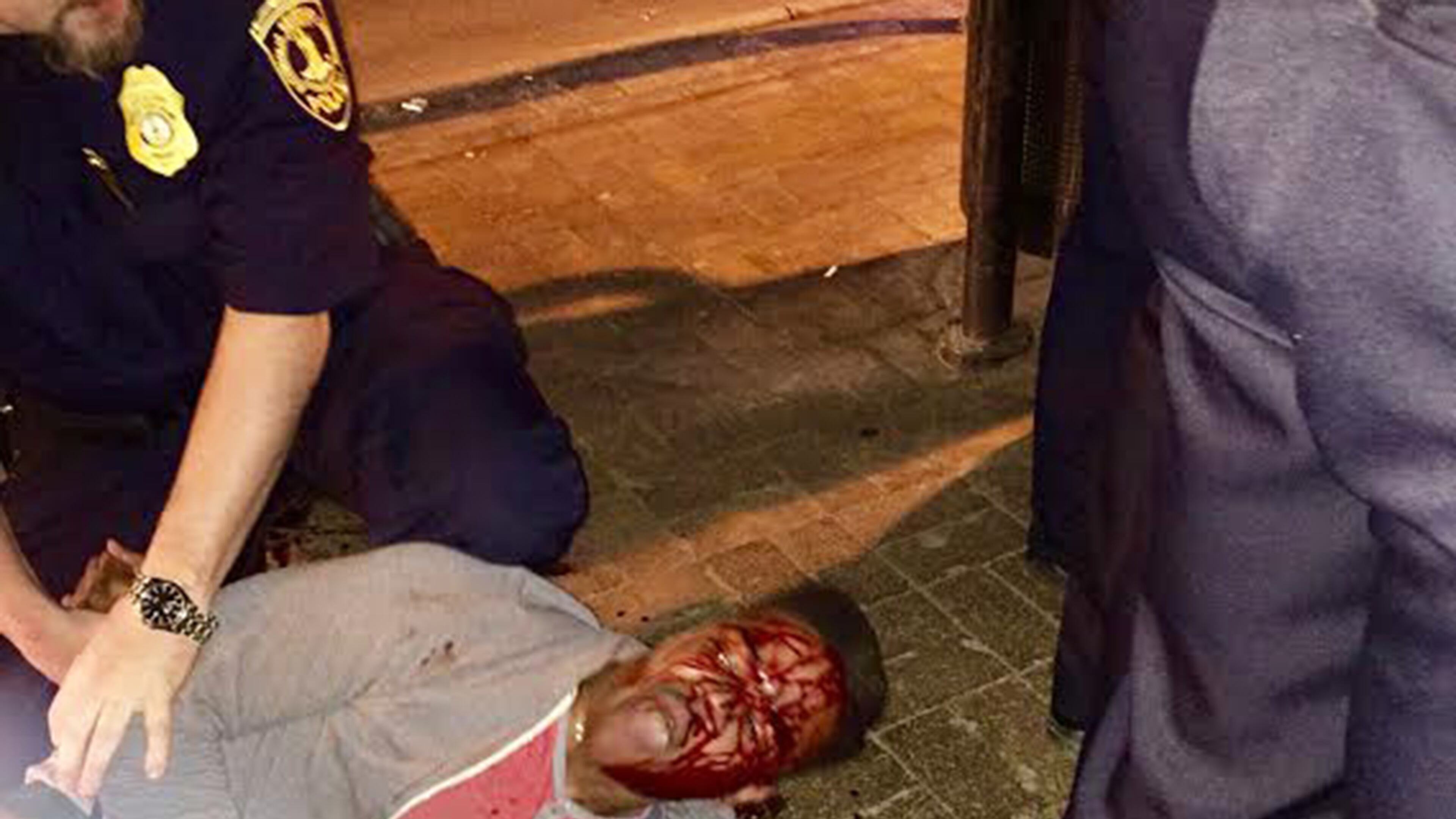 In this photo provided by Bryan Beaubrun, Martese Johnson is held down by an officer Wednesday, March 18, 2015, in Charlottesville, Va. Court records show that Johnson was charged with obstruction of justice without force and public swearing or intoxication. The Virginia Gov. Terry McAuliffe is calling for an investigation into the arrest of the student. (AP Photo/Bryan Beaubrun)