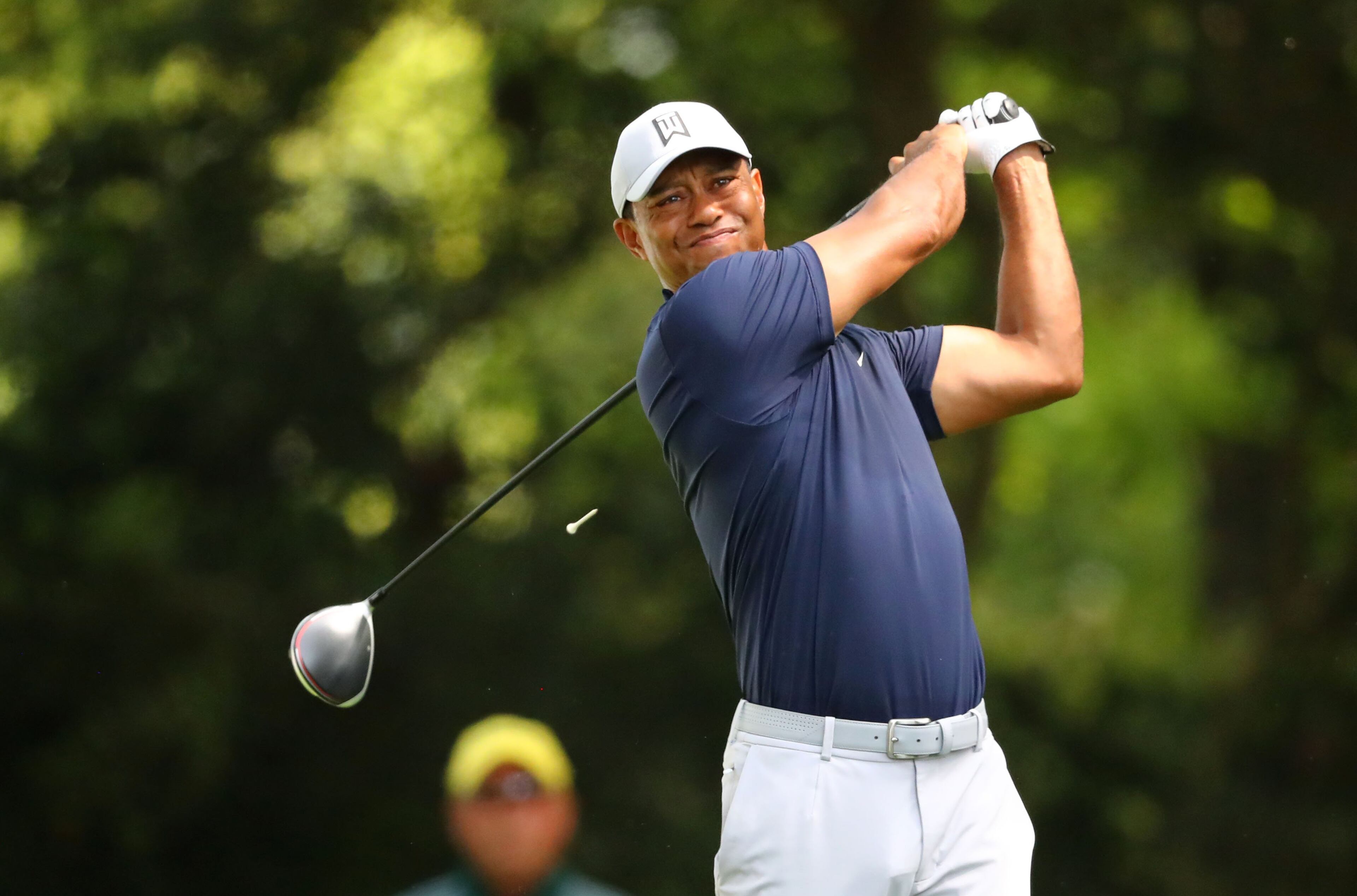 First round from Augusta: Tiger Woods hits his tee shot on the 2nd hole during Thursday's play at Augusta National Golf Club. Woods has won four Masters championships, the last in 2005. (Curtis Compton/ccompton@ajc.com)