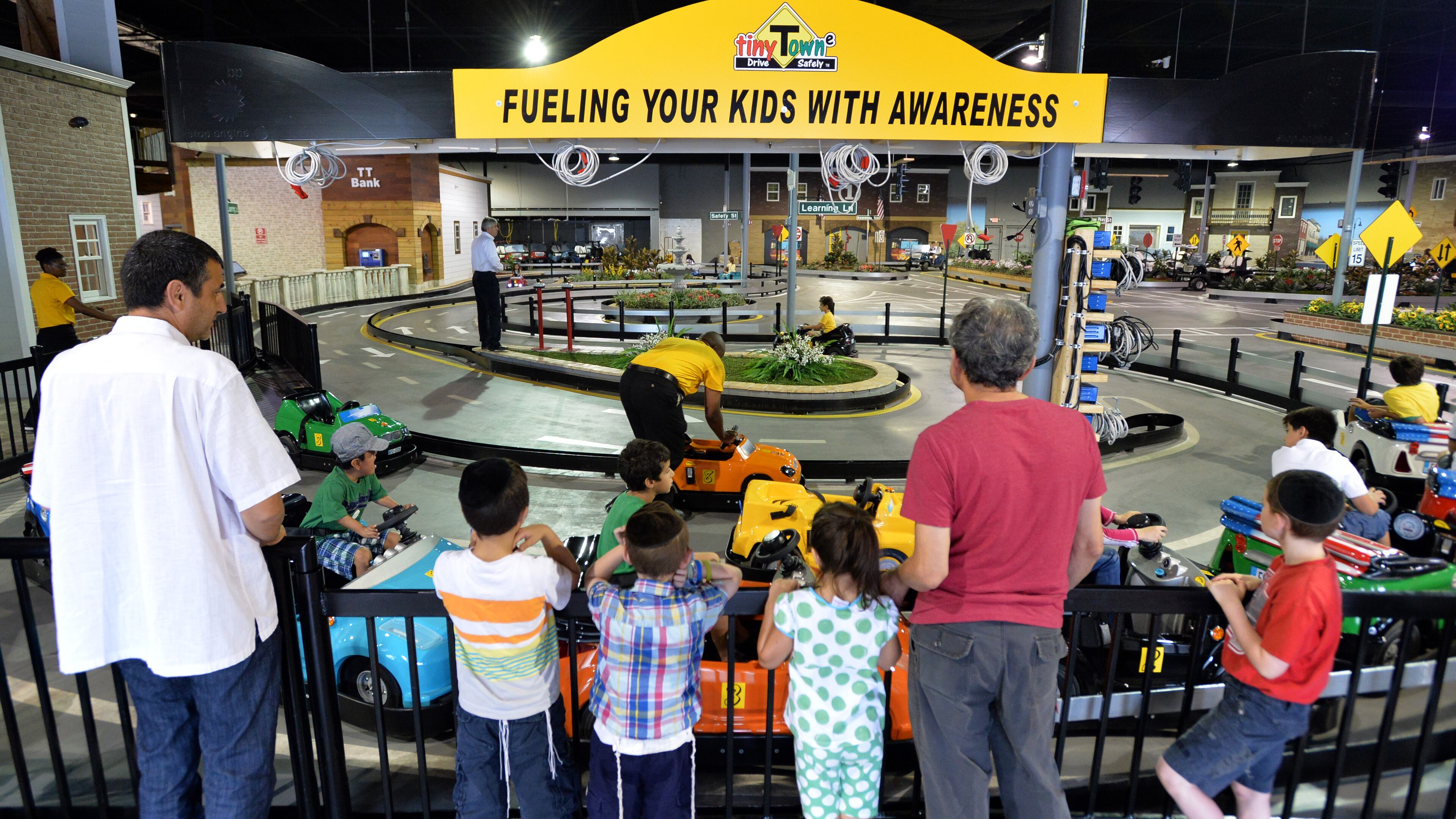 Children learn to respect road signs and other drivers July 8, 2014 at Tiny Towne in Norcross. The facility introduces children ages 3 and older to real-life driving experiences and helps them steer away from dangerous, reckless driving.