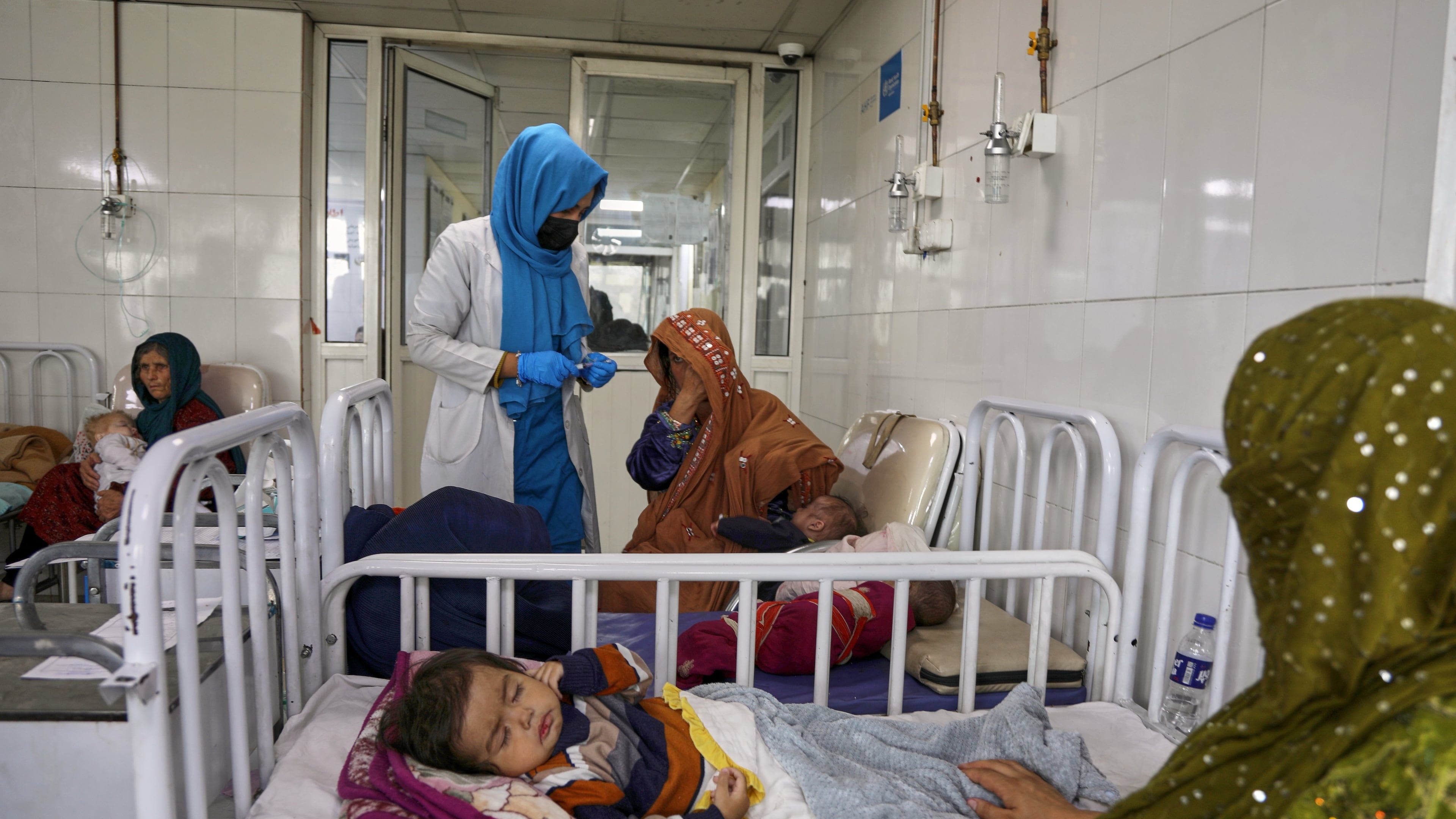 FILE - Afghan women care for their children in the malnutrition ward at Indira Gandhi Children's Hospital in Kabul, Afghanistan, Feb. 15, 2026. (AP Photo/Siddiqullah Alizai, File)