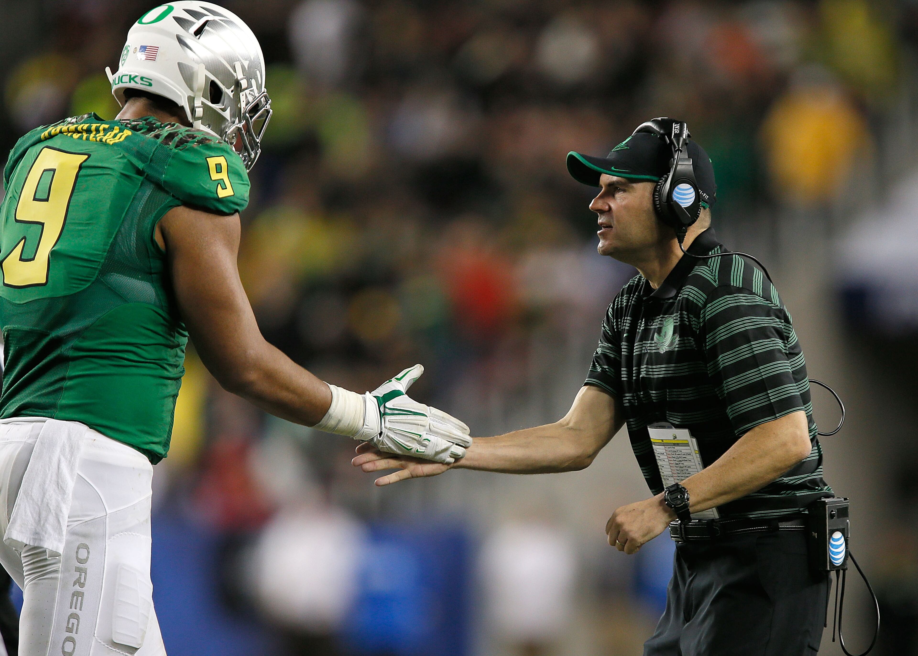 Arik Armstead makes his coach, Oregon's Mark Helfrich, happy while helping the Ducks defeat Arizona in the Pac-12 Championship game in December. (Photo by Brian Bahr/Getty Images)