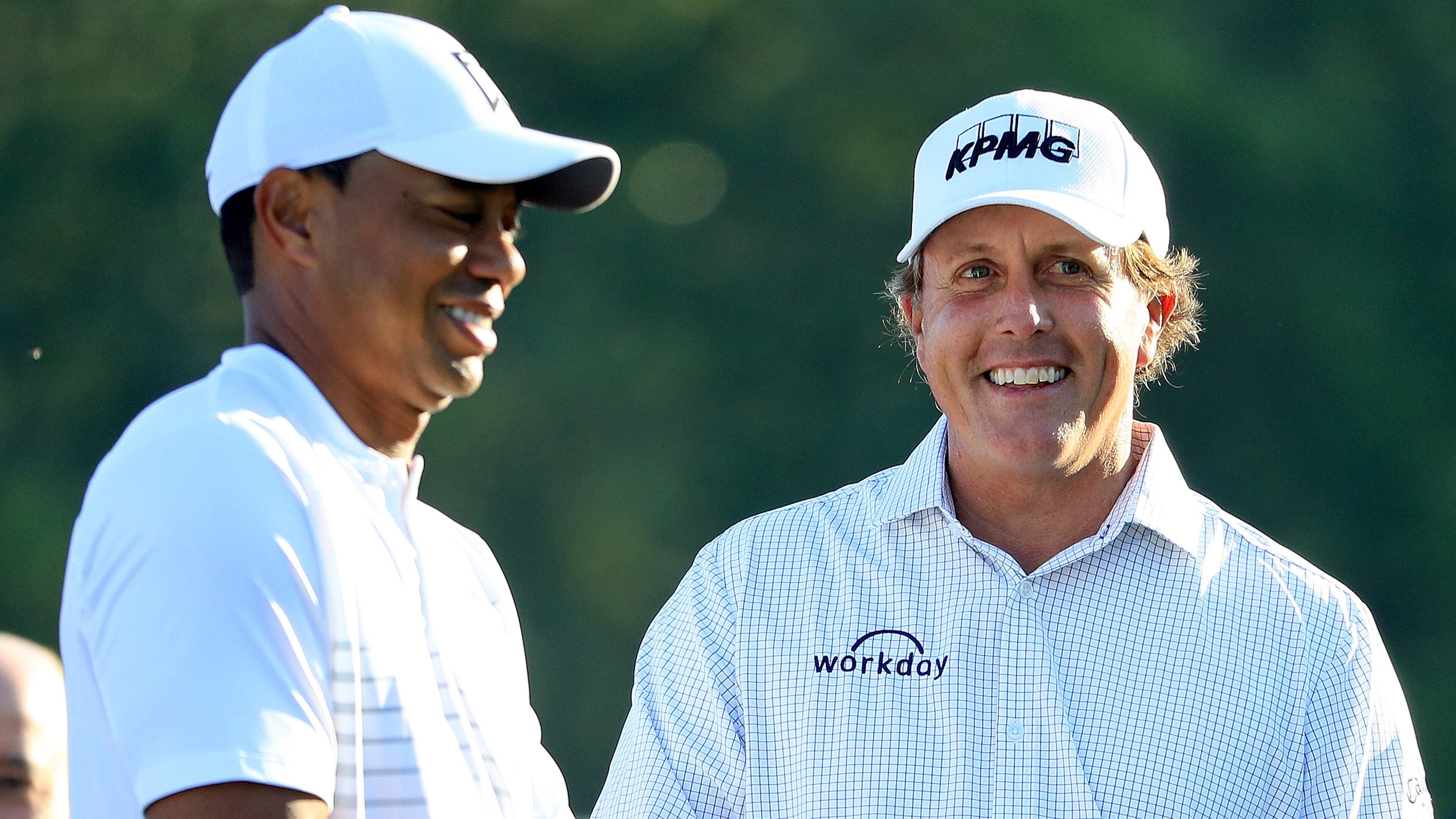 Past Masters champions Tiger Woods and Phil Mickelson talk on the 10th hole during a practice round Tuesday, April 3, 2018, prior to the start of the 2018 Masters Tournament at Augusta National Golf Club.