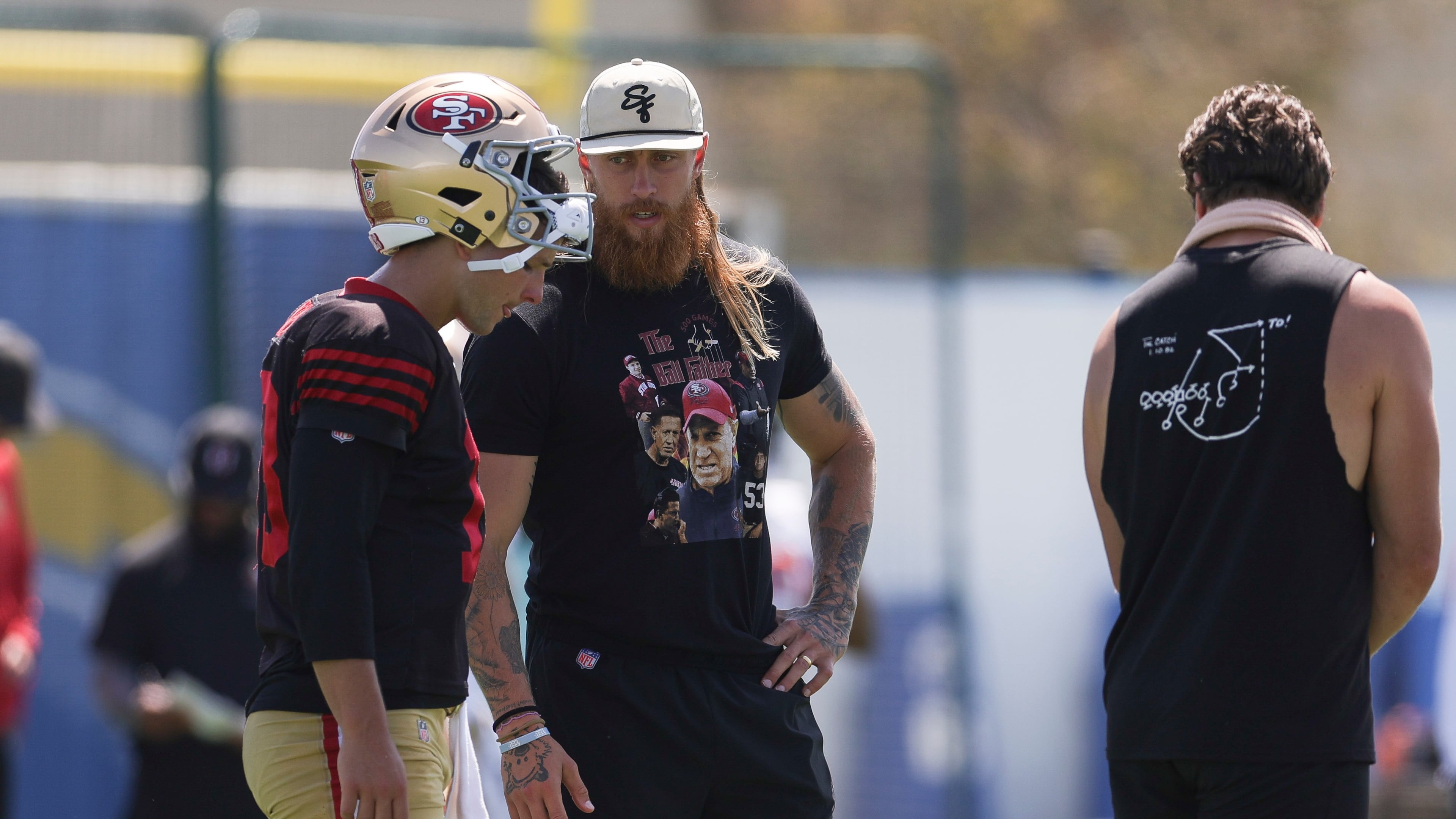 San Francisco 49ers quarterback Brock Purdy (13) talks with tight end George Kittle during a joint NFL football practice with the Los Angeles Chargers, Tuesday, Aug. 18, 2026, in El Segundo, Calif. (AP Photo/Ryan Sun)