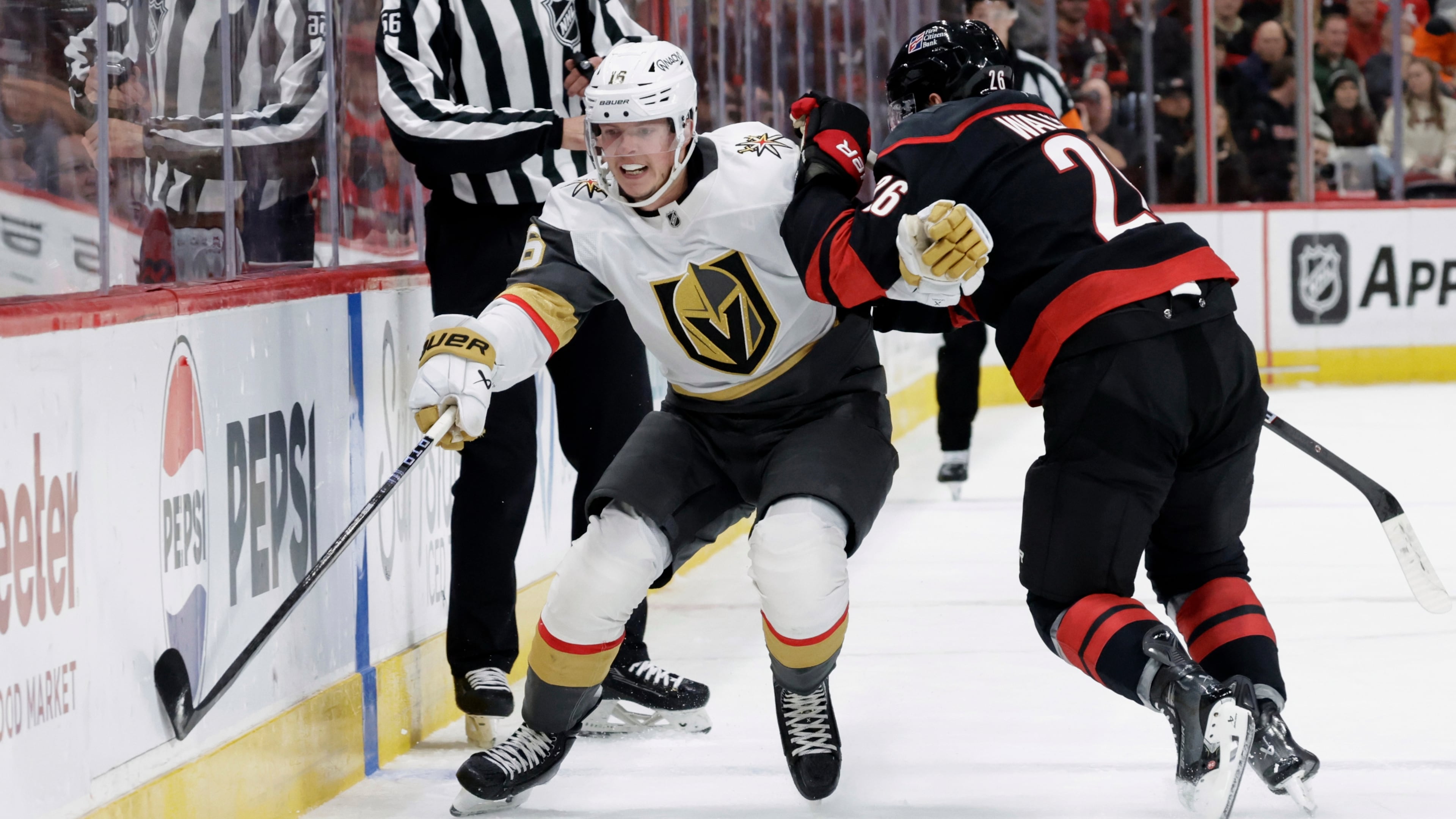 FILE - Vegas Golden Knights right wing Pavel Dorofeyev (16) and Carolina Hurricanes defenseman Sean Walker (26) vie for the puck during the first period of an NHL hockey game Oct. 28, 2025, in Raleigh, N.C. (AP Photo/Chris Seward, File)
