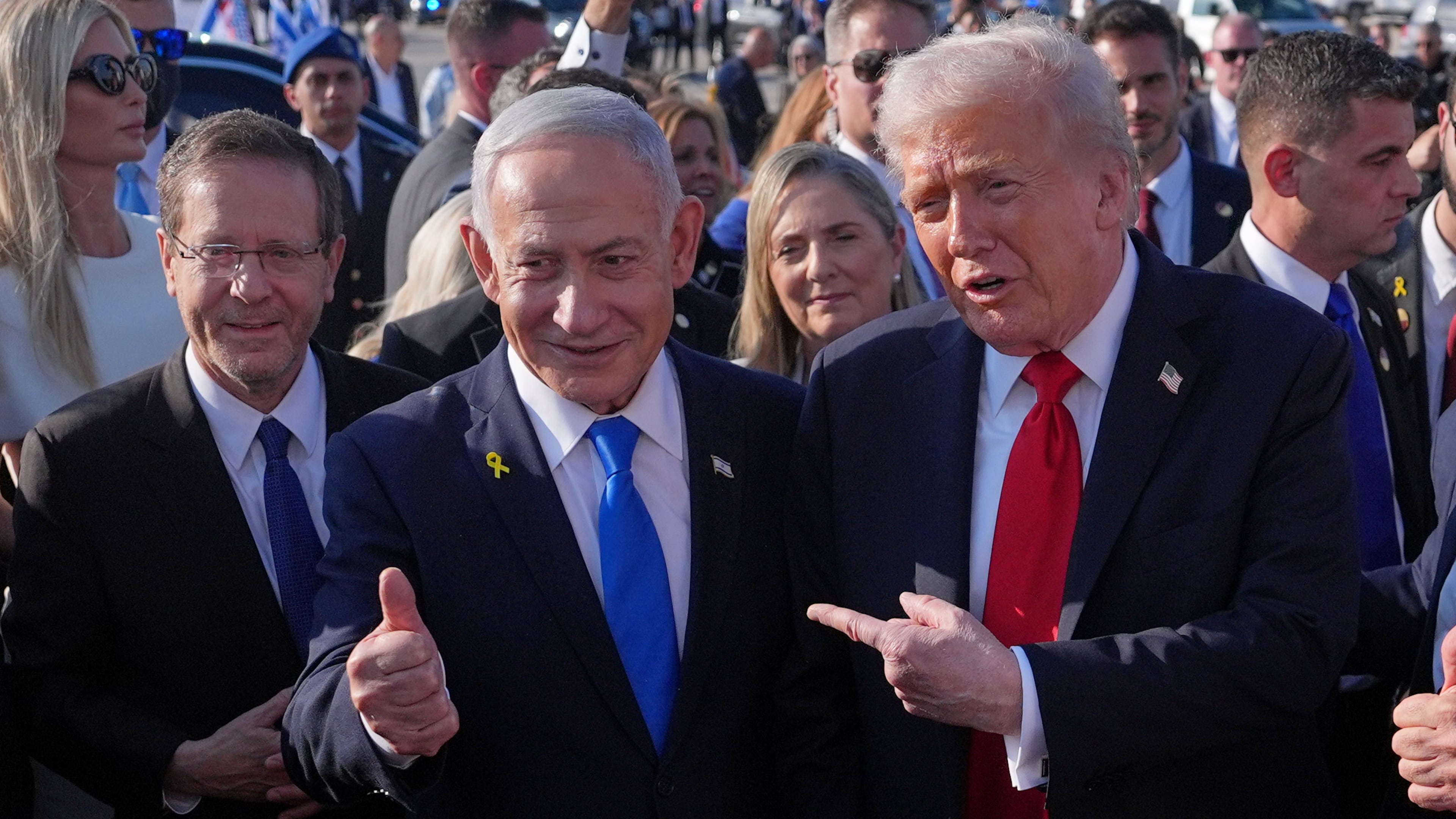 FILE - President Donald Trump poses for a photo with Israel's Prime Minister Benjamin Netanyahu before he boards Air Force One at Ben Gurion International Airport, Oct. 13, 2025, near Tel Aviv, as Israel's President Isaac Herzog watches at left. (AP Photo/Evan Vucci, File)