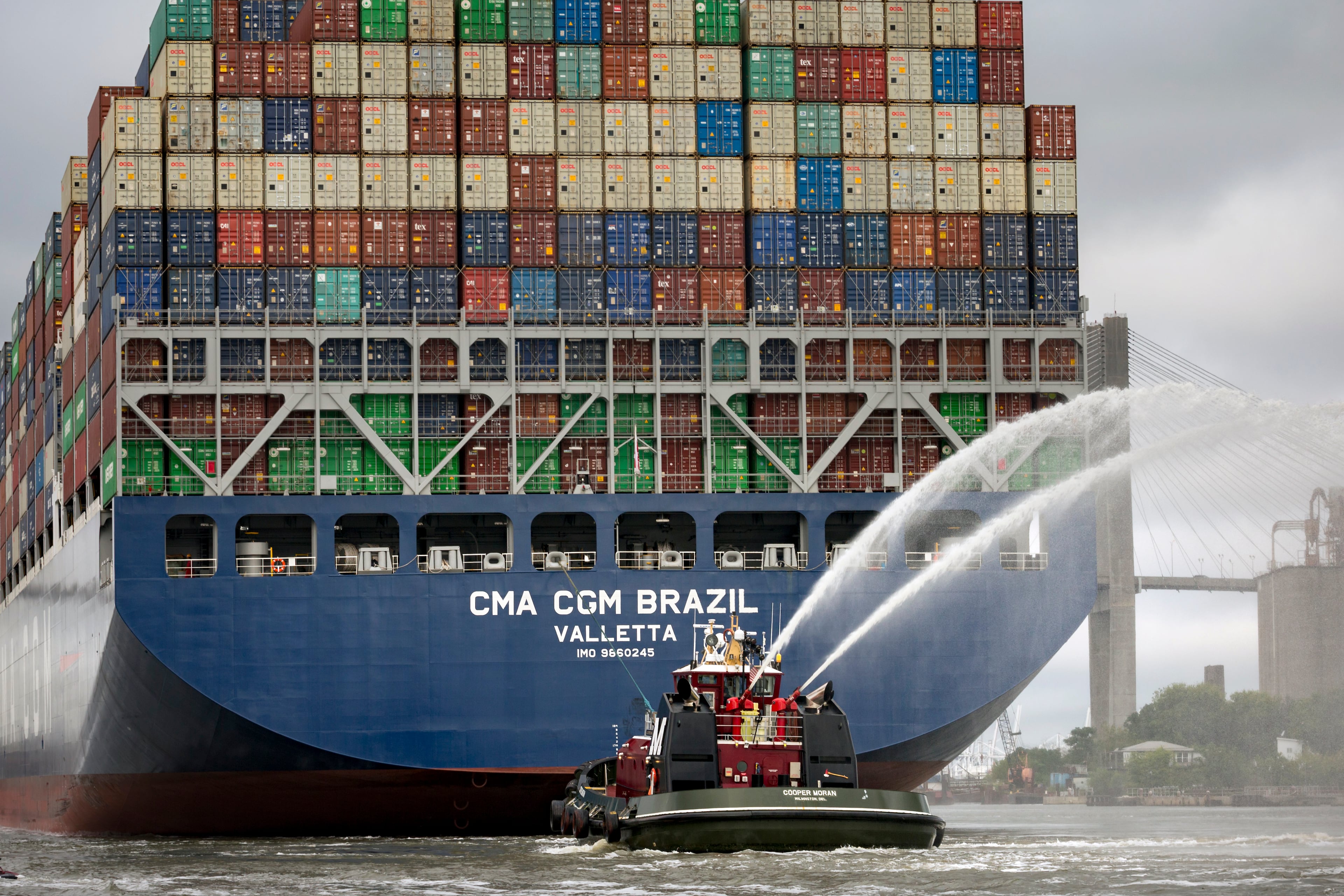 SAVANNAH, GA - SEPTEMBER 18, 2020: The Moran tugboat Cooper Moran sprays water in celebration as it escorts the 167-foot wide container ship CMA CGM Brazil as it sails up the Savannah River to the Georgia Ports Authority's Garden City Terminal, Friday, Sept., 18, 2020, in Savannah, Ga. (AJC Photo/Stephen B. Morton)