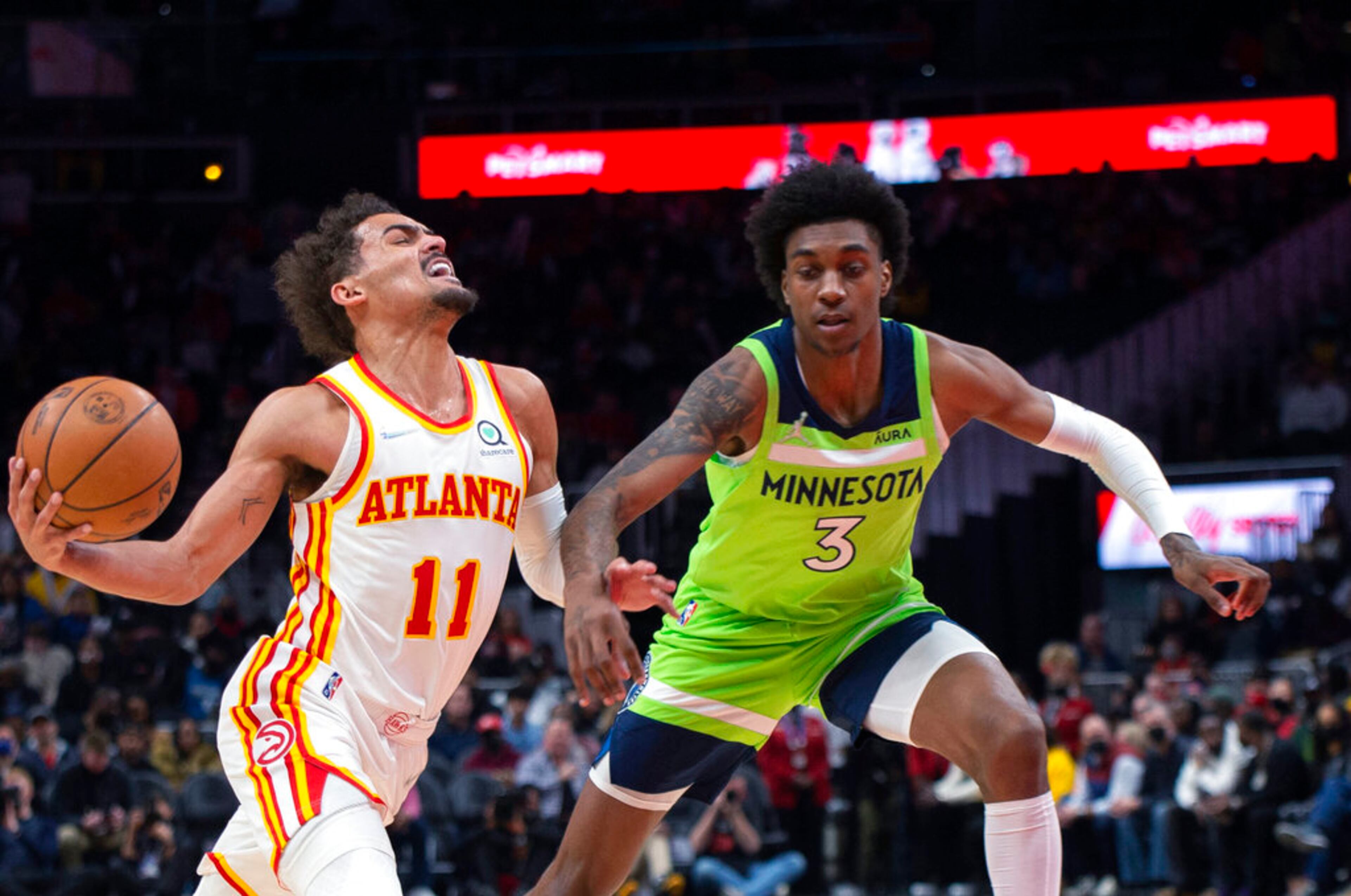 Minnesota Timberwolves forward Jaden McDaniels (3) fouls Atlanta Hawks guard Trae Young (11) during the first half of an NBA basketball game Wednesday, Jan. 19, 2022, in Atlanta. (AP Photo/Hakim Wright Sr.)