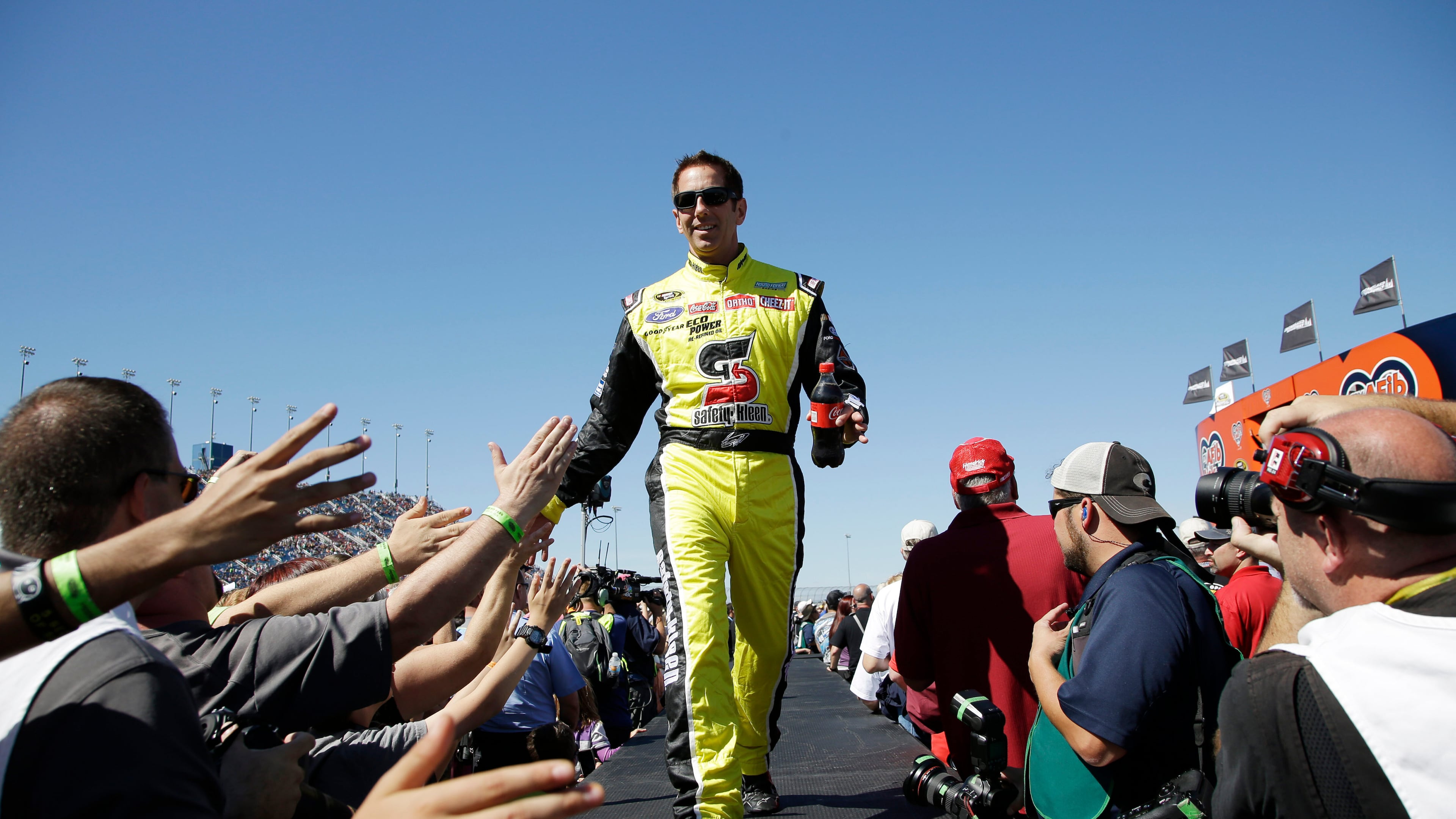 FILE - Greg Biffle greets fans during drivers introduction before the NASCAR Sprint Cup Series auto race at Chicagoland Speedway, Sept. 20, 2015, in Joliet, Ill. (AP Photo/Nam Y. Huh, File)