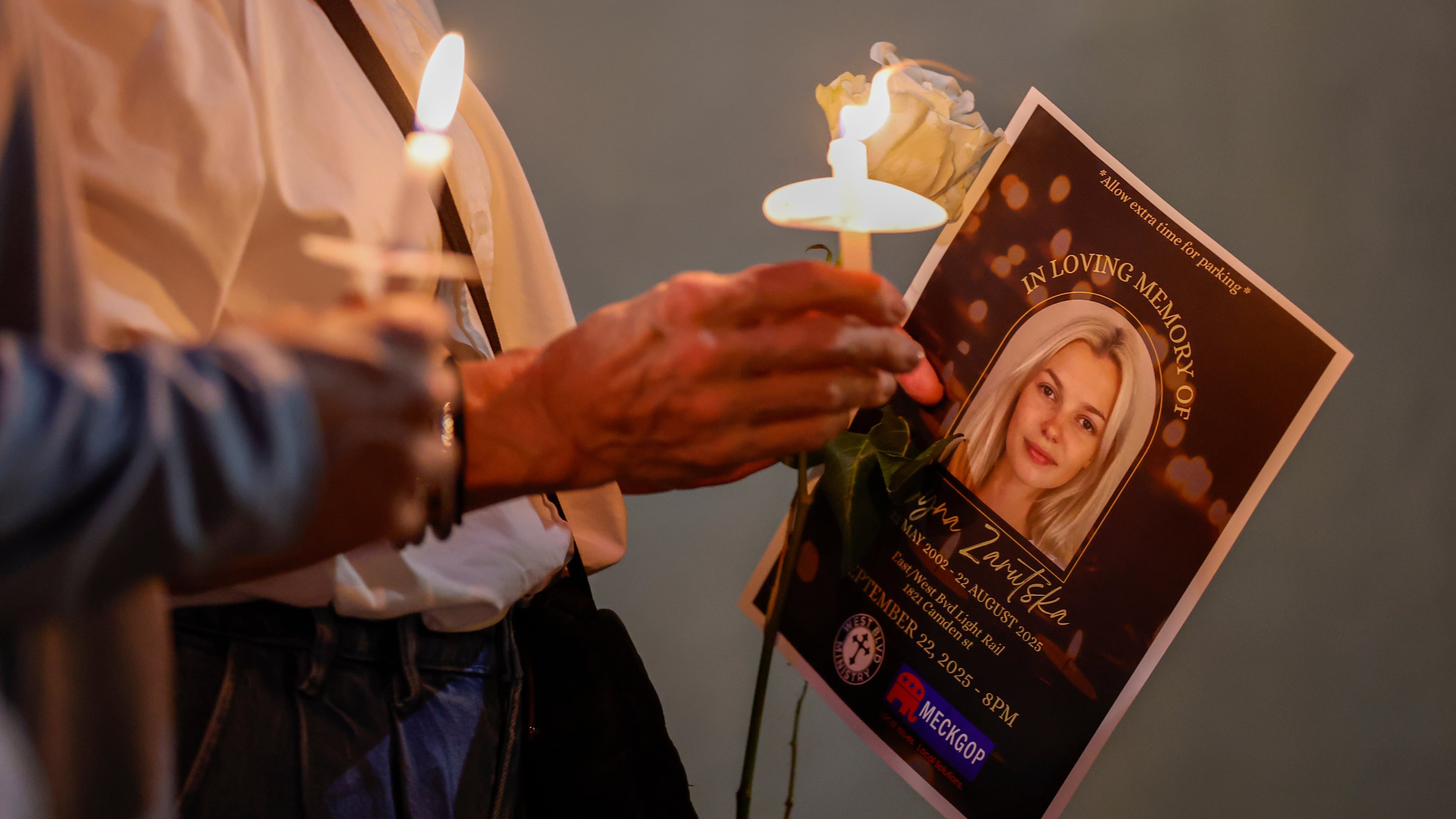 FILE - Community members hold candles as they gather for a vigil honoring the life of Iryna Zarutska, who was fatally stabbed on a commuter train, Sept. 22, 2025, in Charlotte, N.C. (AP Photo/Nell Redmond, File)