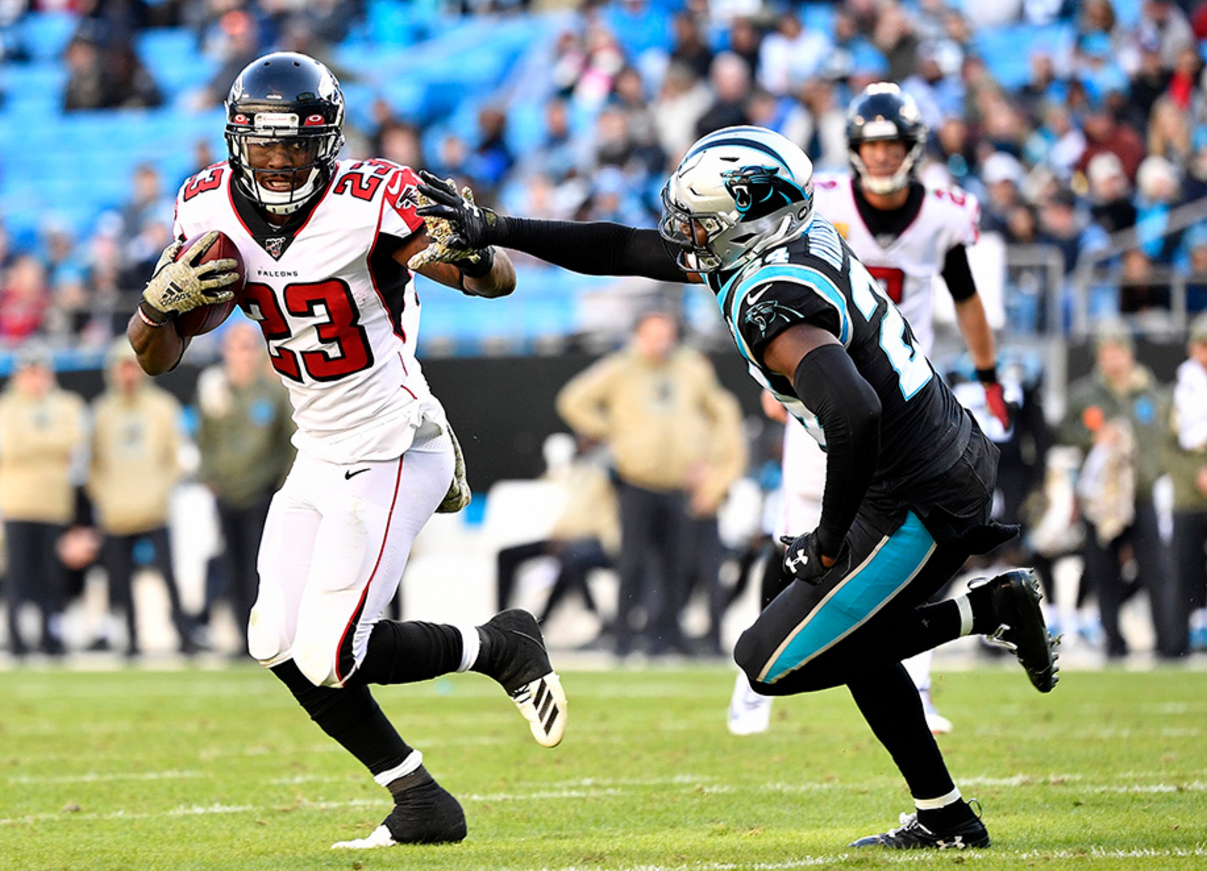 Falcons running back Brian Hill runs against Carolina's James Bradberry during the third quarter Sunday, Nov. 17. 2019, at Bank of America Stadium in Charlotte.