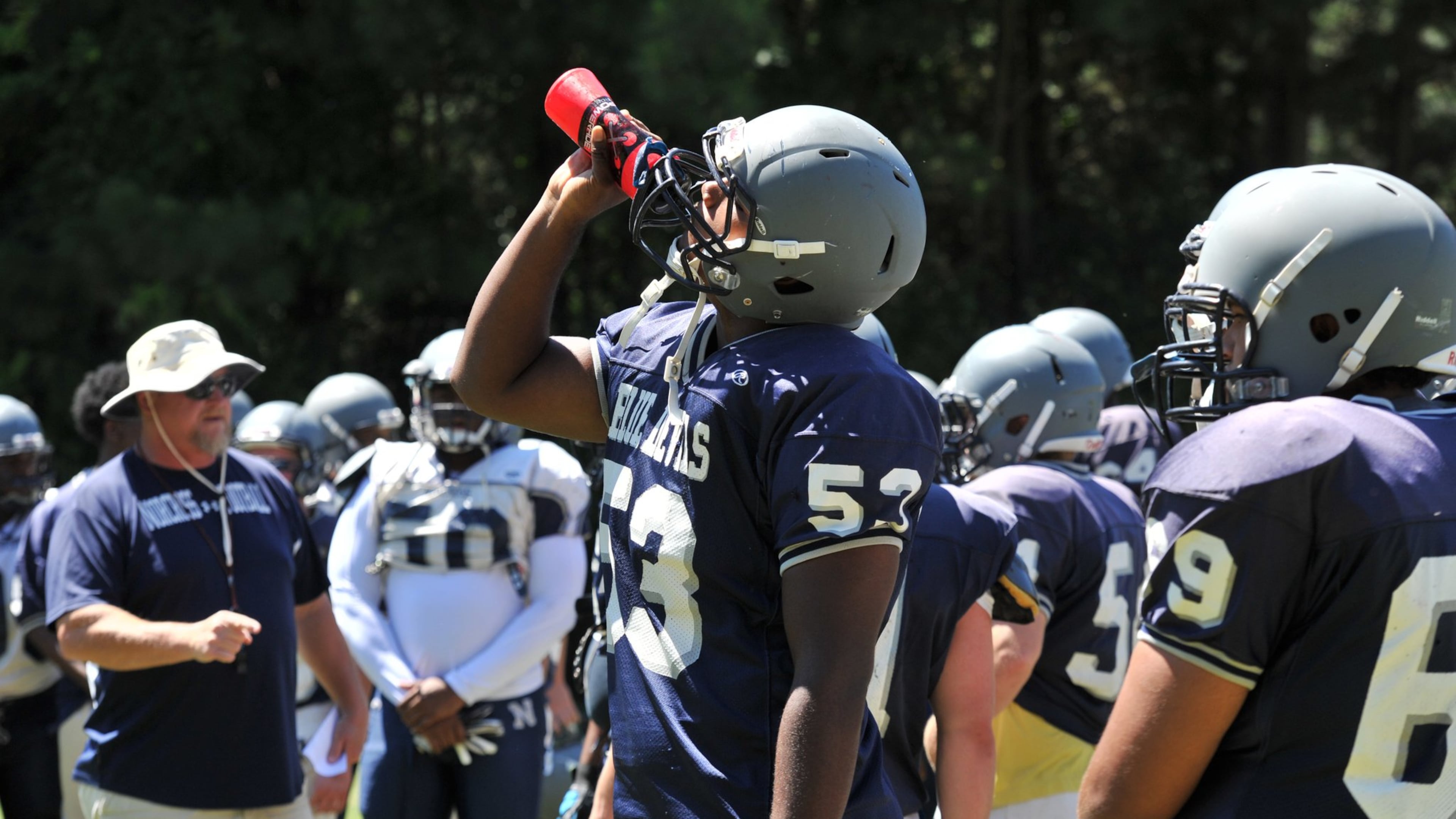 Norcross high school player D’Andre Plantin takes a water break during their practice at Norcross High School in Norcross on Wednesday, August 13, 2014. (Hyonsub Shin/AJC)