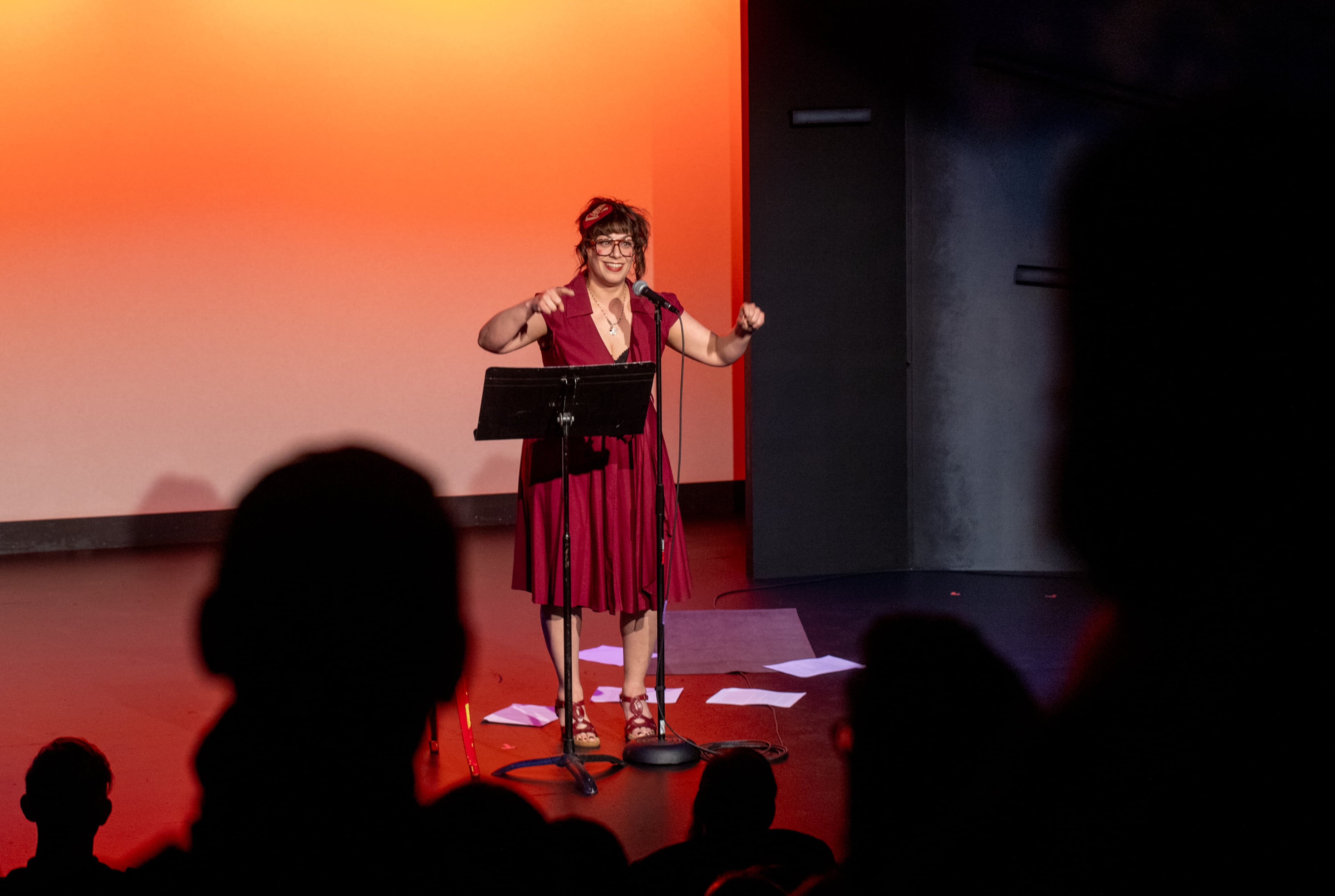 “Too Fast, Too Festivus” cast member Gina Rickicki, shown at a Write Club storytelling competition, says, "The more people are able to experience laughter, joy and relief as a group, the stronger we are.” (Jenni Girtman for the AJC)