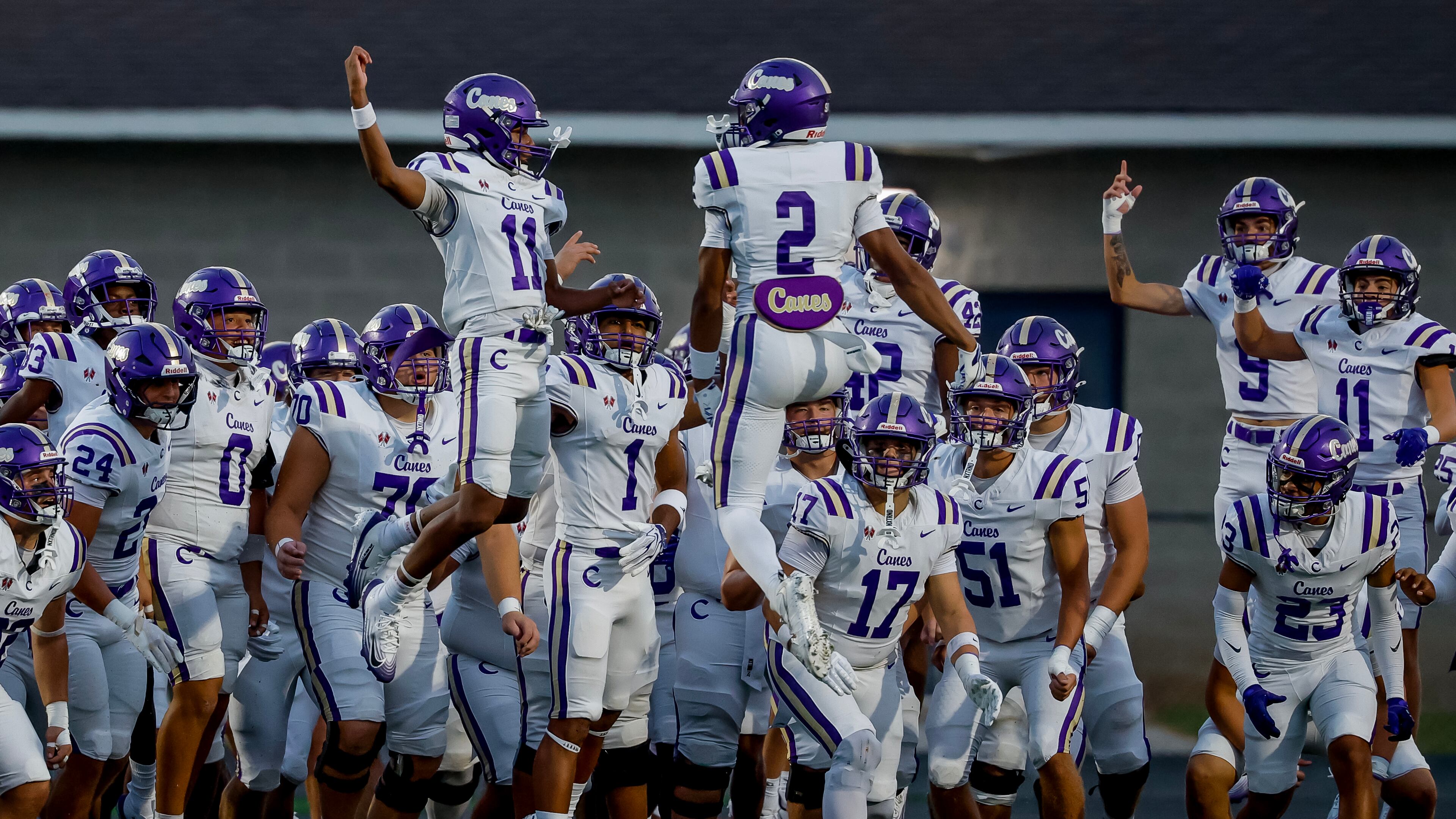 Cartersville’s Lance Tippett (left) and Grayson Warmack lead their teammates onto the field before their game against Hiram on Friday, Aug. 21, 2026, in Hiram. (Erik S. Lesser for the AJC)