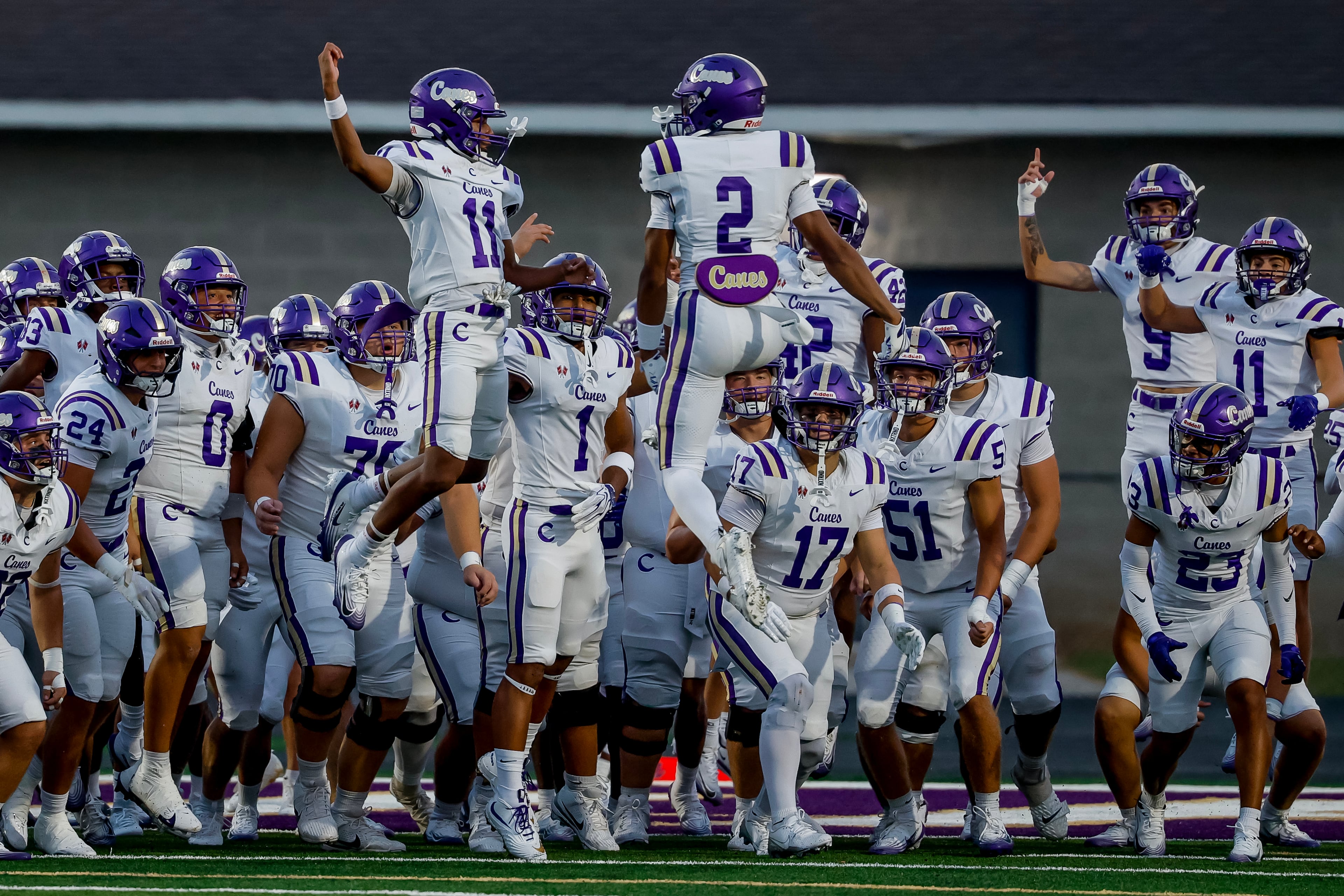 Cartersville wide receiver Lance Tippett (left) and safety Grayson Warmack lead their teammates onto the field before their game against Hiram on Friday, Aug. 21, 2026, in Hiram. (Erik S. Lesser for the AJC)