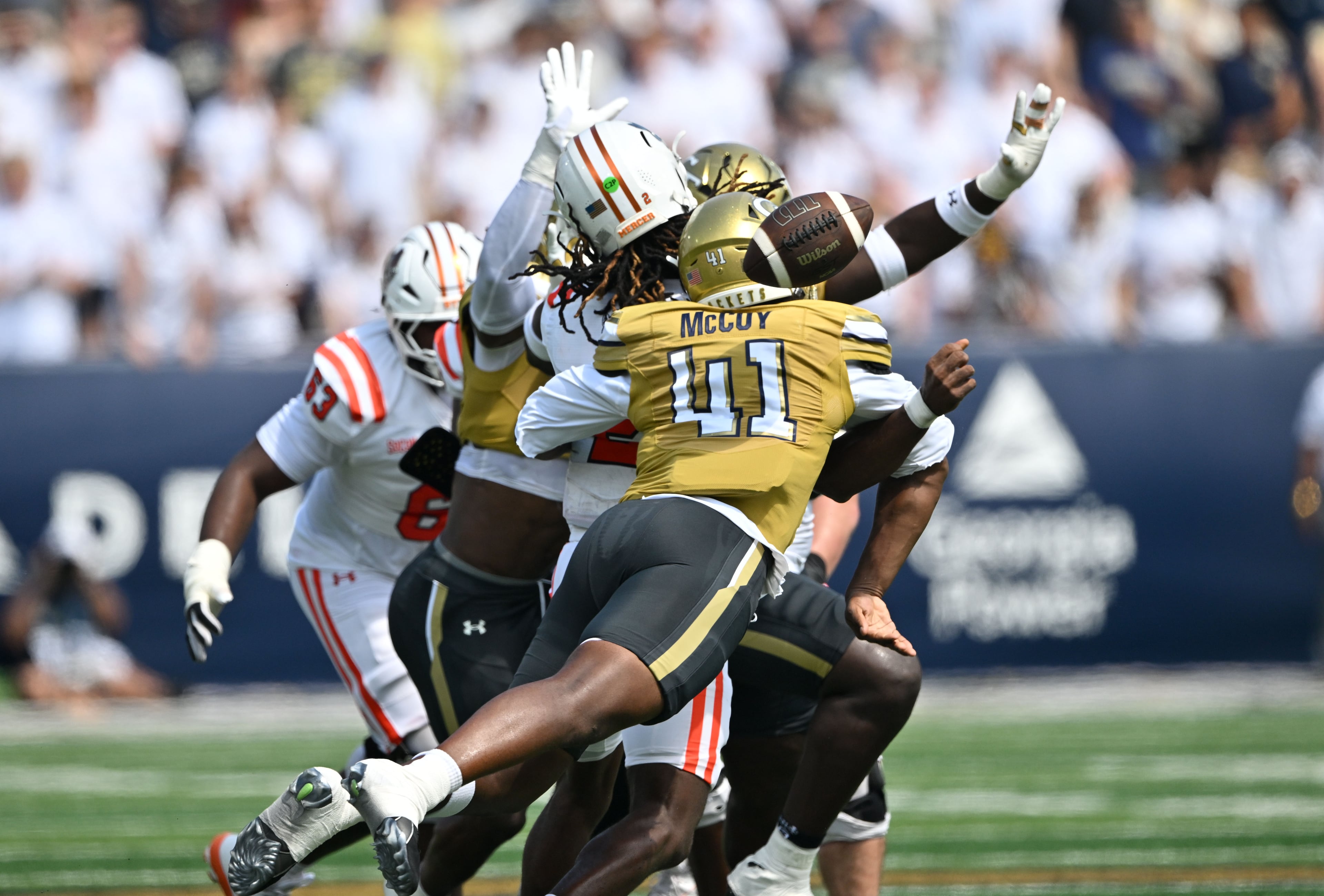 Mercer quarterback Jaylen King (2) is hit by Georgia Tech defensive end Taje McCoy (left) causing a fumble during the first half in an NCAA college football game at Bobby Dodd Stadium on Saturday, Sept. 19, 2026, in Atlanta. (Hyosub Shin/AJC)