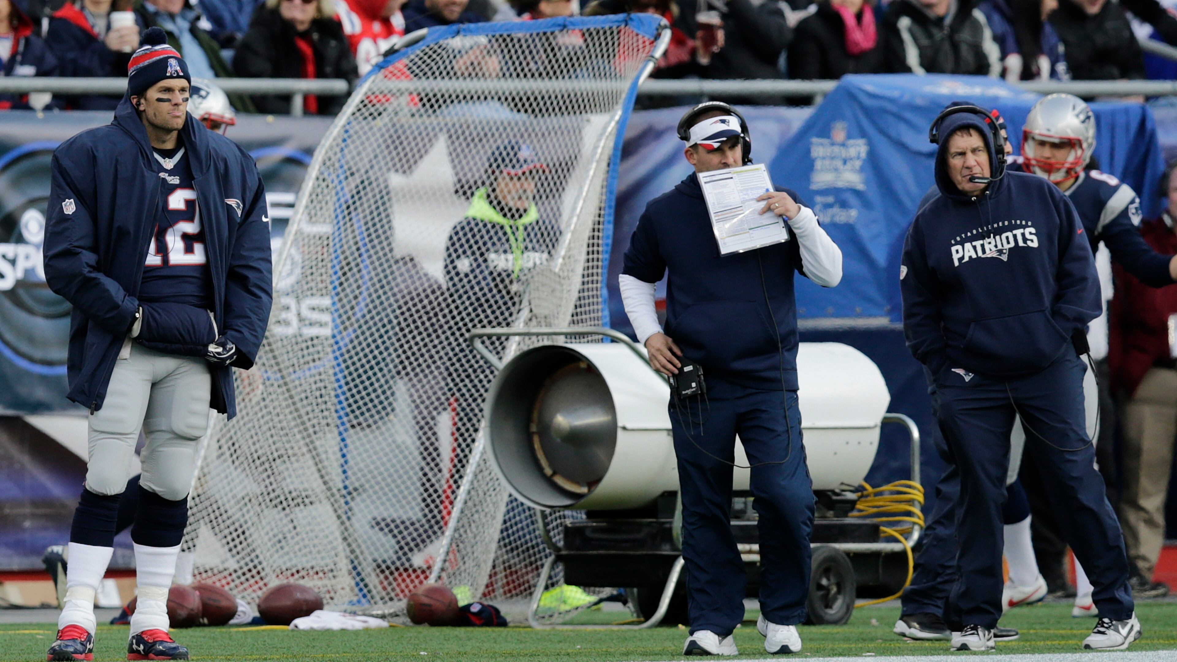New England Patriots quarterback Tom Brady (12) on the sidelines with offensive coordinator Josh McDaniels, center, and head coach Bill Belichick in the second half of an NFL football game against the Buffalo Bills, Sunday, Dec. 28, 2014, in Foxborough, Mass. (AP Photo/Charles Krupa) Should Josh McDaniels (center, between Tom Brady and Bill Belichick) be considered favorite for Falcons' job? (AP)