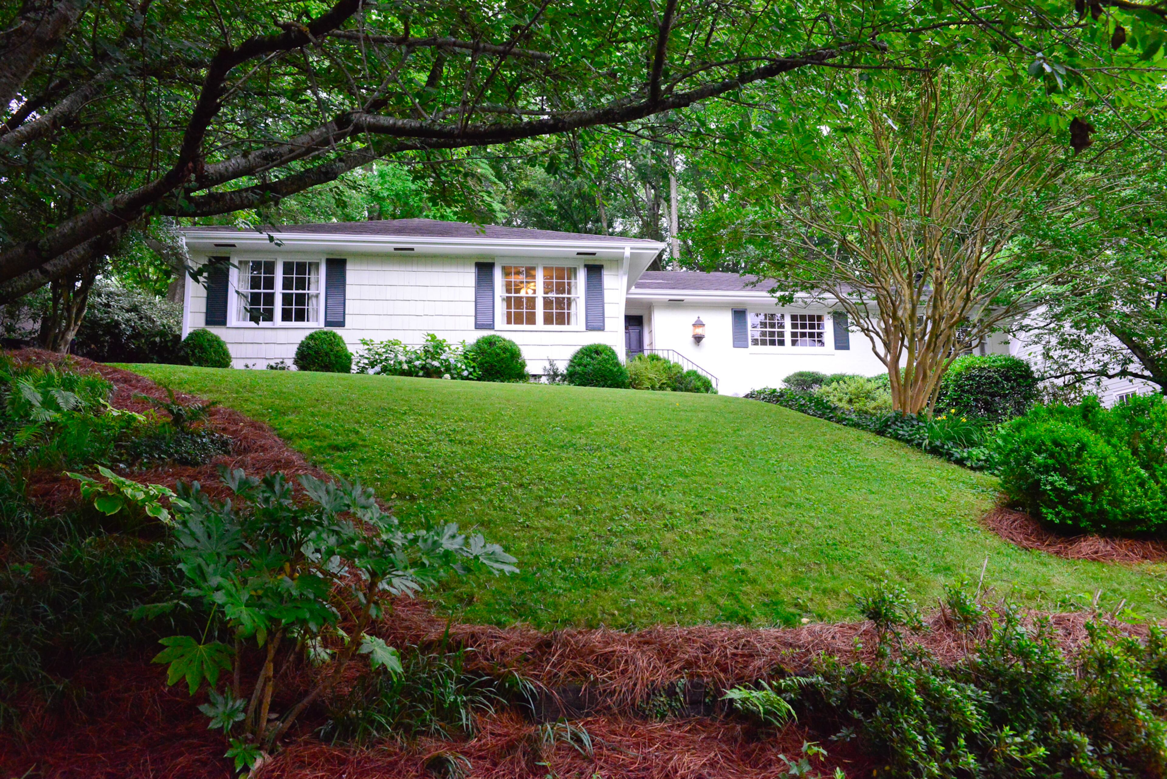 Amid an abundance of greenery and trees, the three-bedroom, two-and-a-half bath Buckhead home has about 2,300 square feet. The home was built in 1951.--Text by Lori Johnston