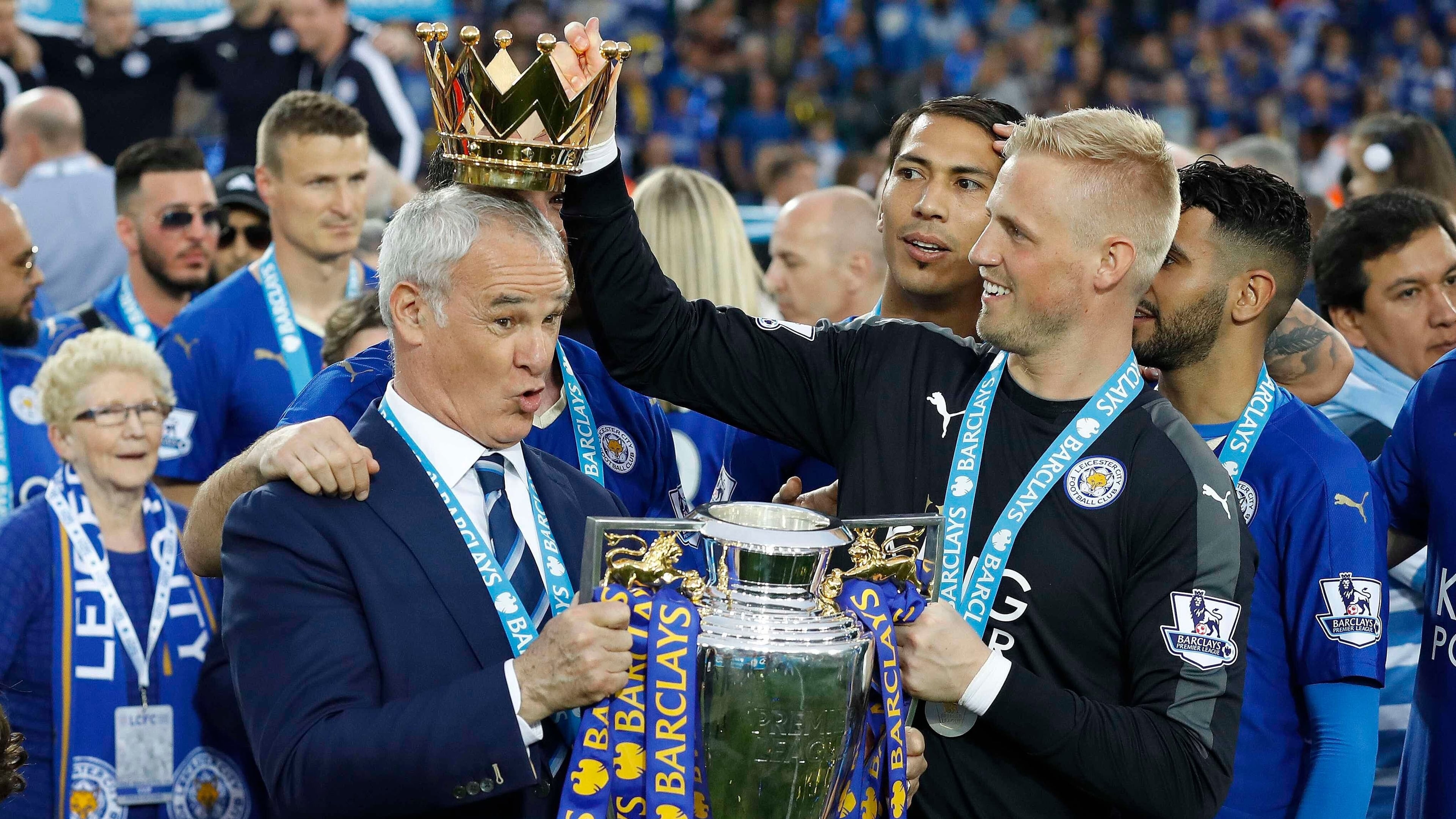 FILE - Leicester City team manager Claudio Ranieri has the crown of the trophy placed on his head by Leicester goalkeeper Kasper Schmeichel as they celebrate becoming the English Premier League soccer champions at King Power stadium in Leicester, England, May 7, 2016. (AP Photo/Matt Dunham, File)
