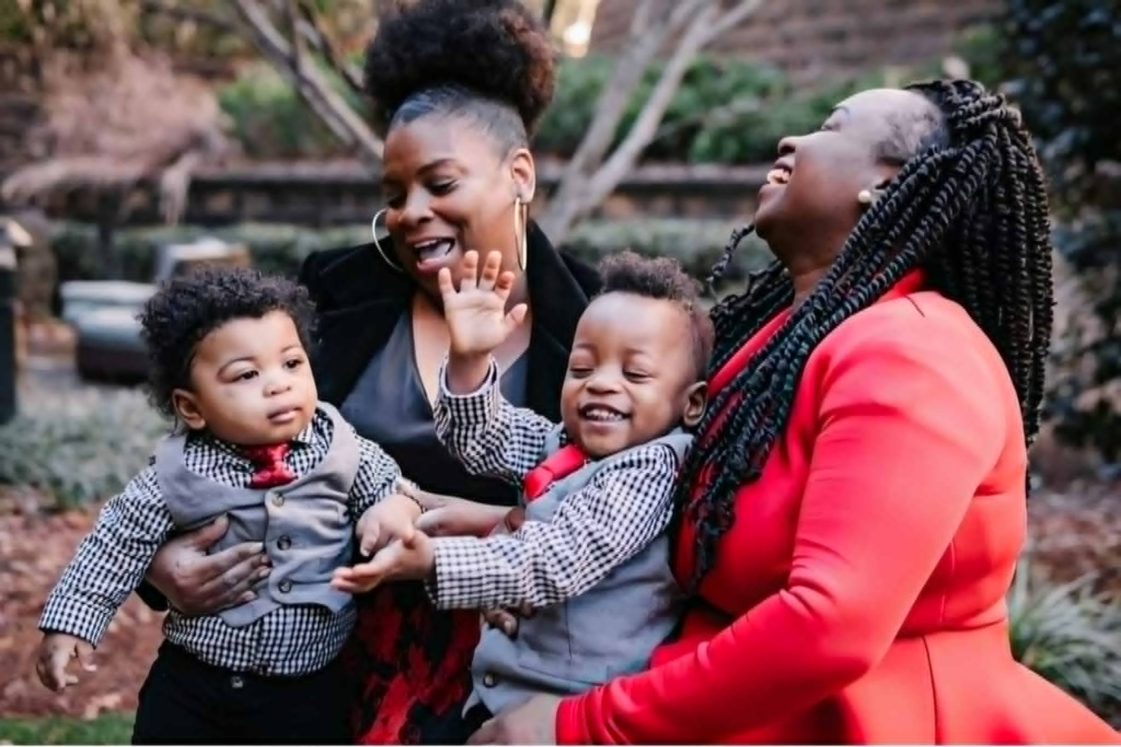 Dee Dee Crawford (red), with her mom international vocalist Brenda Vaughn, and her sonsXavier and Isaiah Crawford.