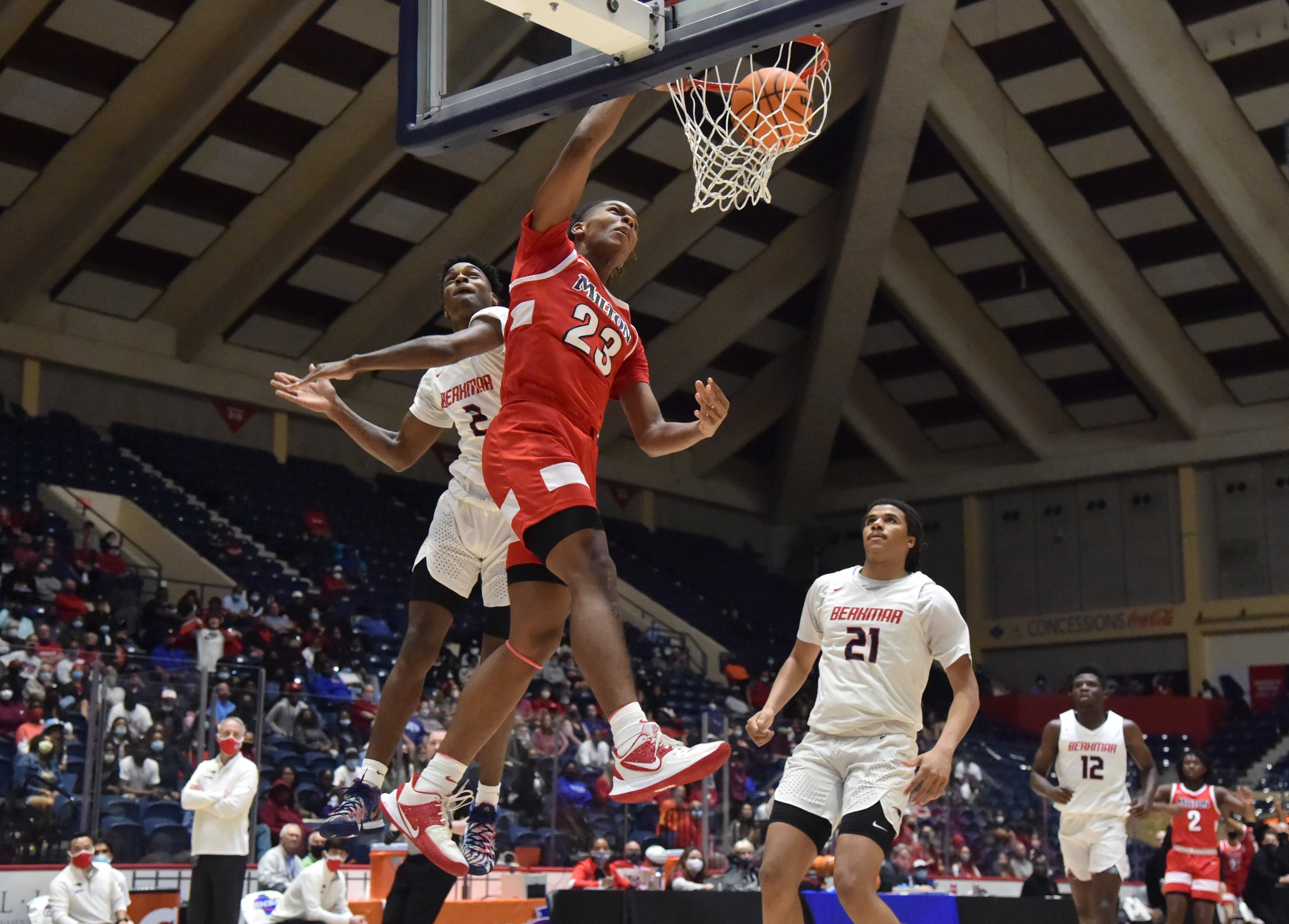 Milton's Kendall Campbell (23) can't be stopped by Berkmar's Jermahri Hill (2). (Hyosub Shin / Hyosub.Shin@ajc.com)