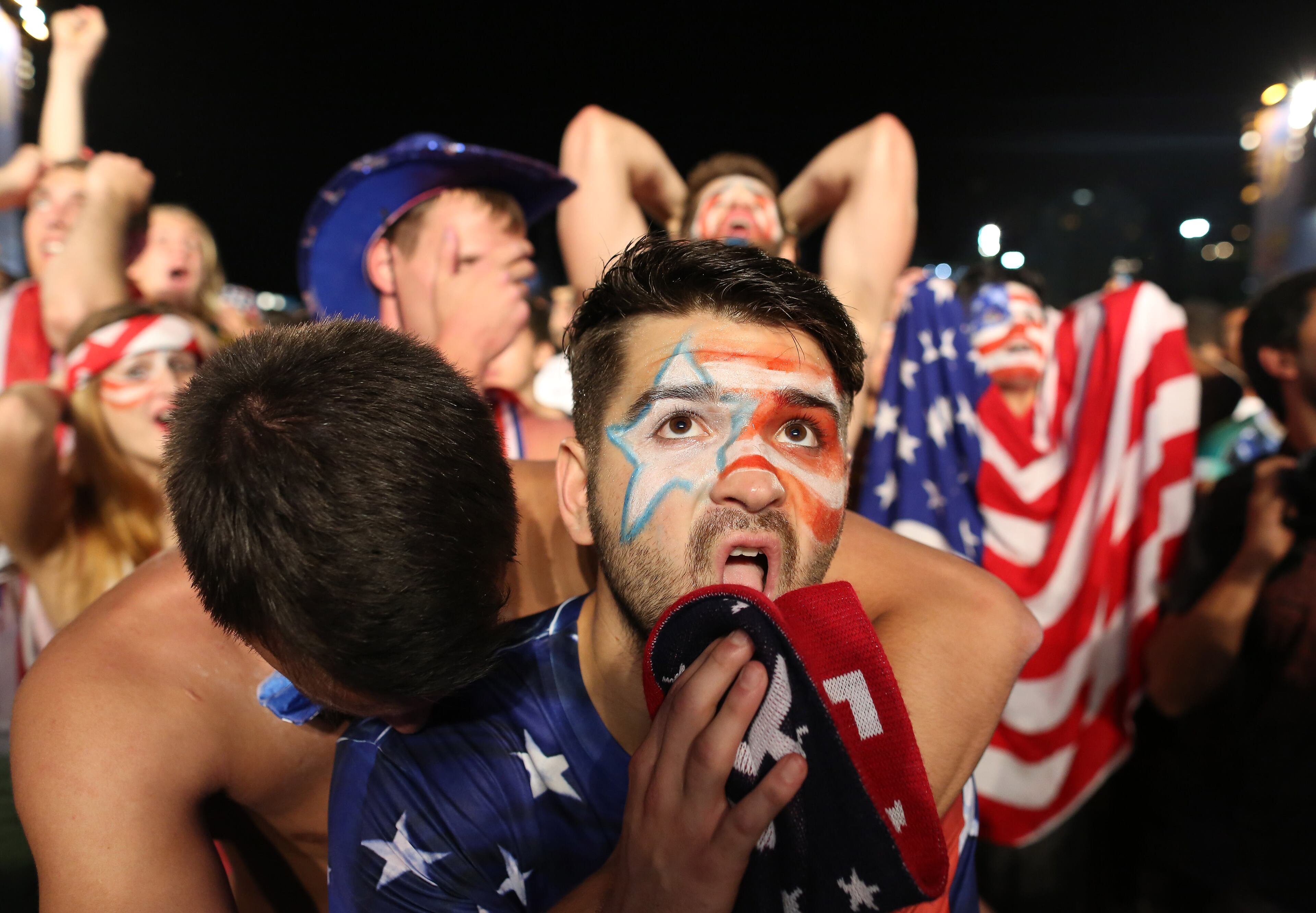 A fan of the U.S. national soccer team reacts with frustration after Portugal scored the second goal at the end of the live telecast of the group G World Cup match between United States and Portugal, inside the FIFA Fan Fest area on Copacabana beach, in Rio de Janeiro, Brazil, on June 22, 2014. Portugal managed to score to tie the Americans 2-2 in the last minutes of the game.