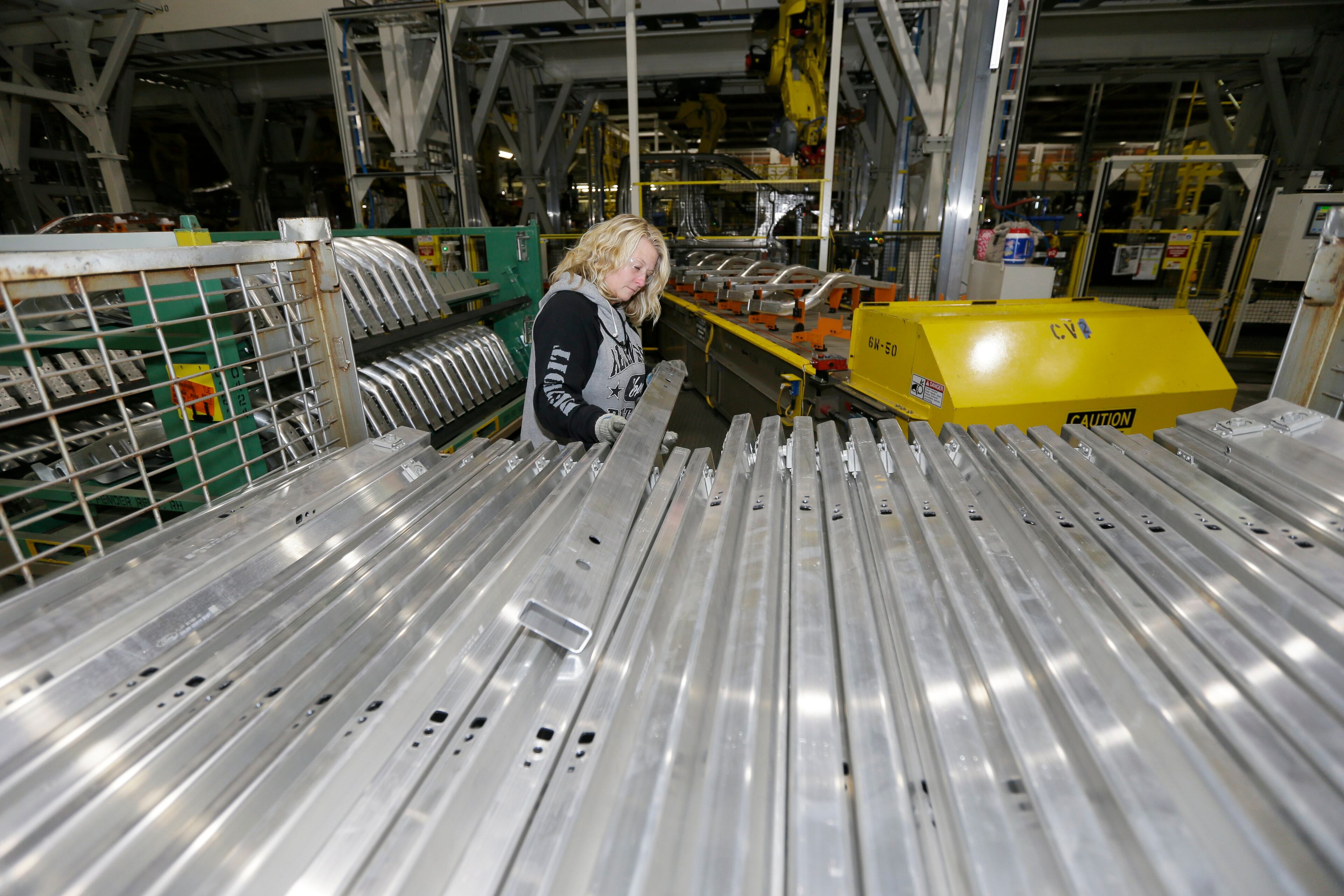 Jennifer Gillesbie works on the frame of the new Ford F-150 truck is assembled at the Rouge Truck Plant in Dearborn, Mich. It's the automaker's biggest bet in decades: an aluminum-sided F-150 that could set a new industry standard _ or cost the company its pickup truck crown. It will arrive on U.S. dealer lots next month. Aluminum _ which is lighter than steel but just as strong _ isn't new to the auto industry, but this is the first time it will cover the entire body of such a high-volume vehicle. (AP Photo/Carlos Osorio)