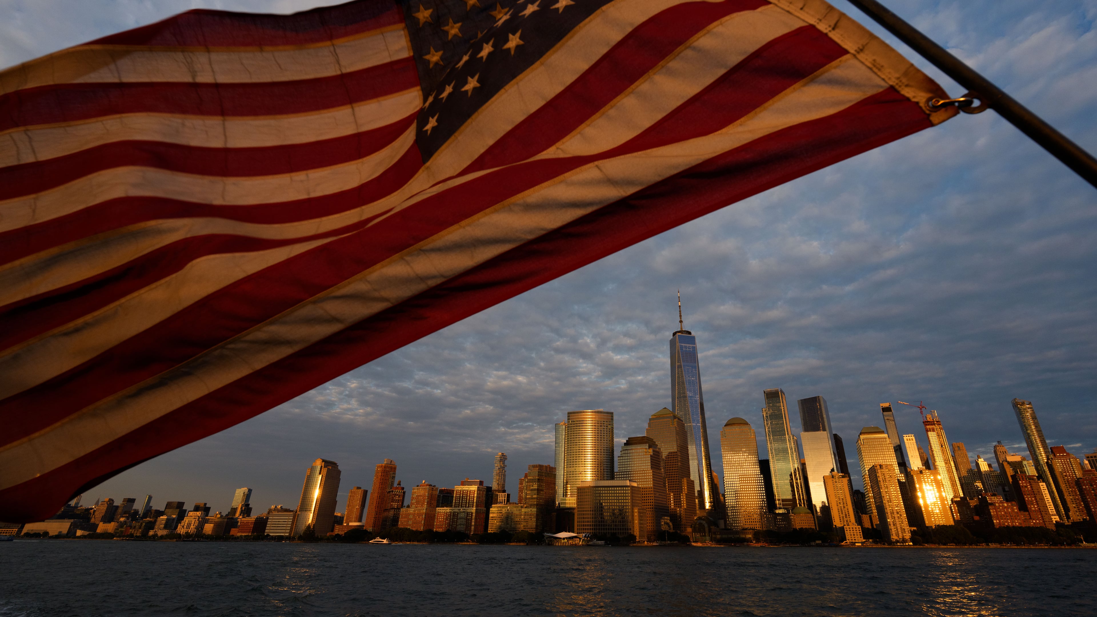 An American flag flies, with the lower Manhattan skyline in background, Wednesday, Sept. 9, 2026, in Jersey City, NJ. (AP Photo/Adam Gray)