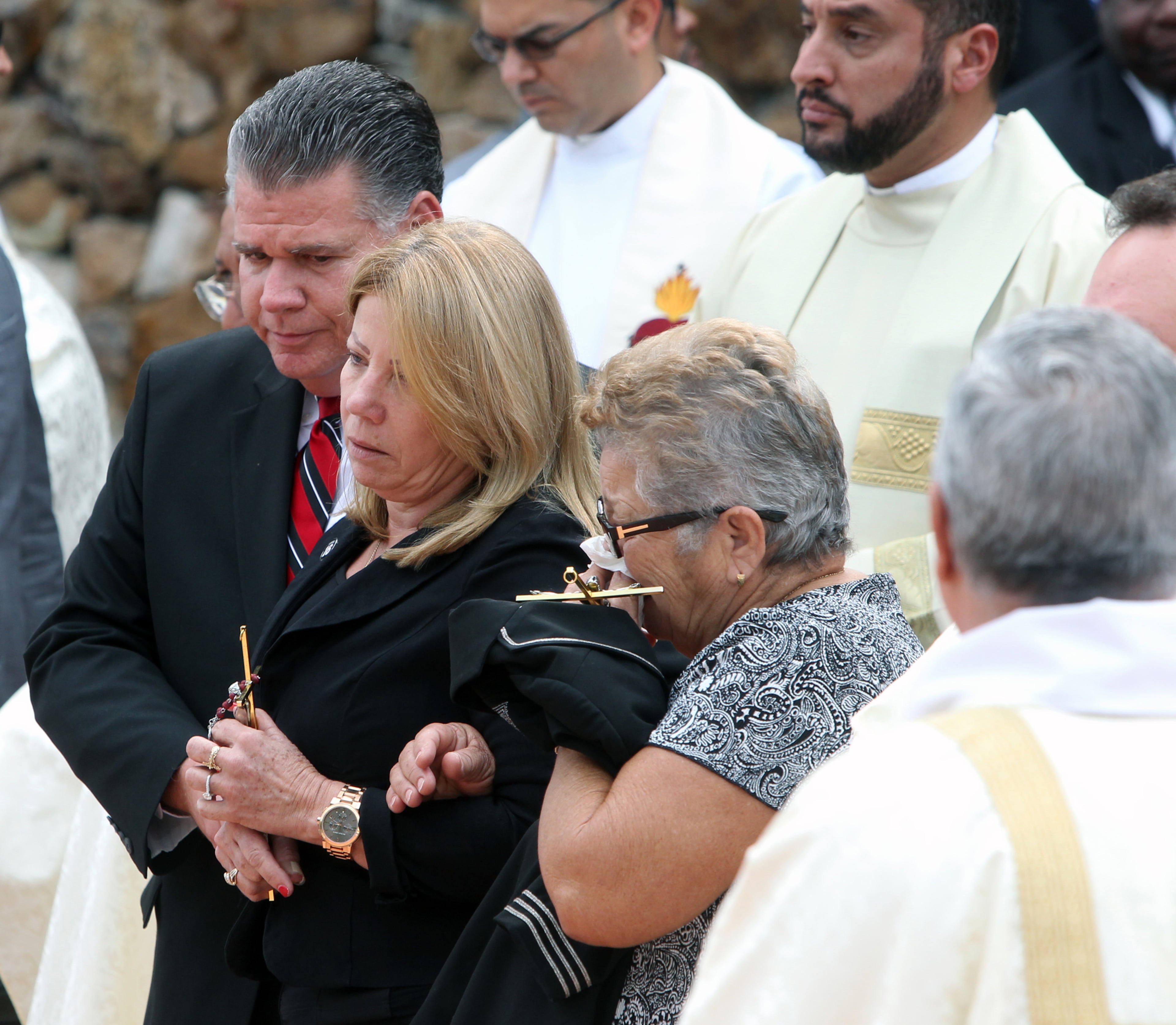 Maritza Fernandez, the mother of Miami Marlins pitcher Jose Fernandez, center, and Olga Fernandez, his grandmother, right, after a memorial service at St. Brendan Catholic Church in Miami on Thursday, Sept. 29, 2016. (Roberto Koltun/El Nuevo Herald/TNS)