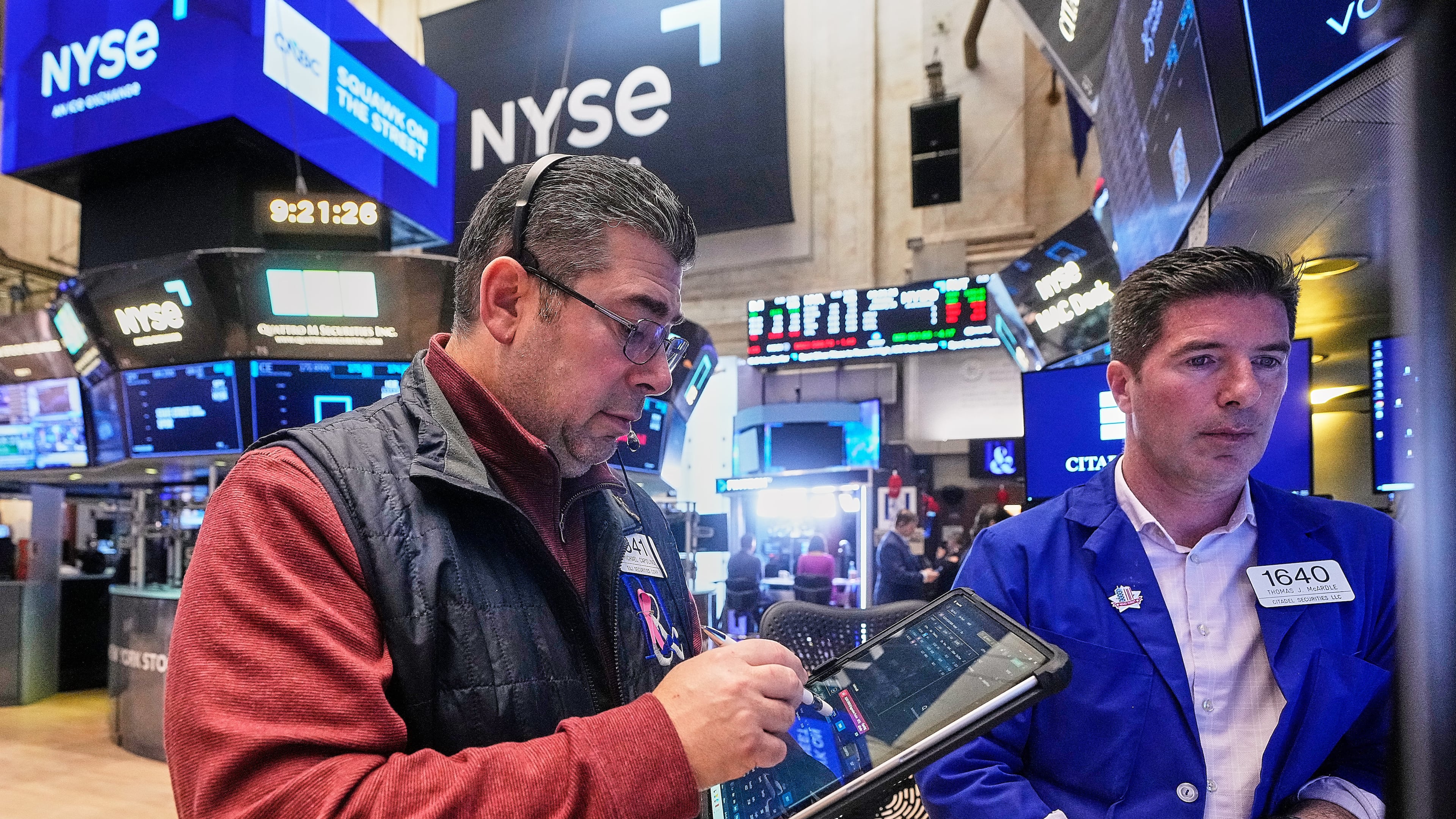 Trader Michael Capolino, left, and Specialist Thomas McArdle work on the floor of the New York Stock Exchange, Monday, Jan. 26, 2026. (AP Photo/Richard Drew)