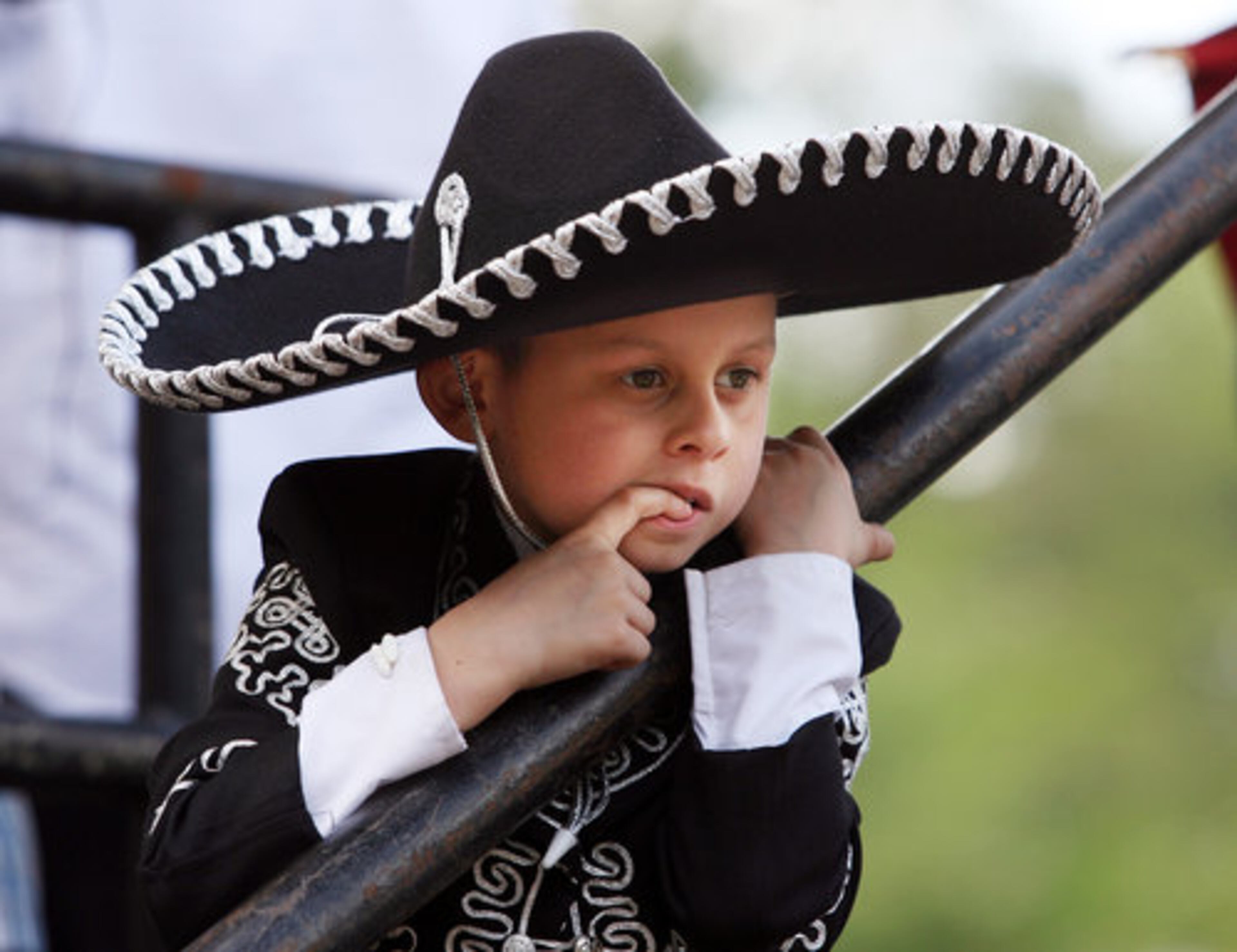 Young singer Adrian Munoz, 7, of Chicago, waits back stage for his turn to perform during the Feria Latina Hispanic festival on Memorial Lawn at Stone Mountain Park.