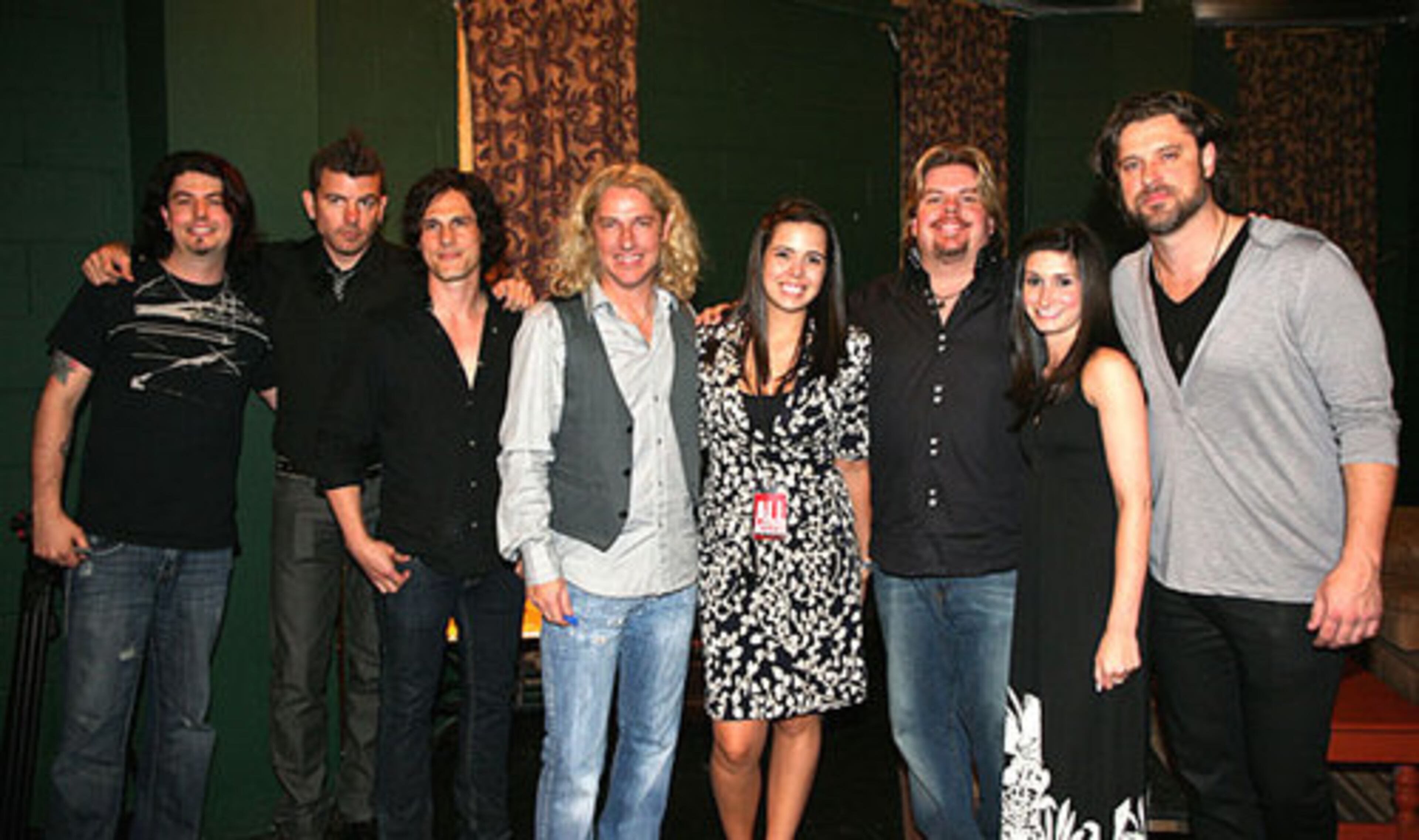 Collective Soul members pose backstage with organizers Katherine McKerrow (fourth from right), Q100's Jeff Dauler, and Megan Maziar (second from right).