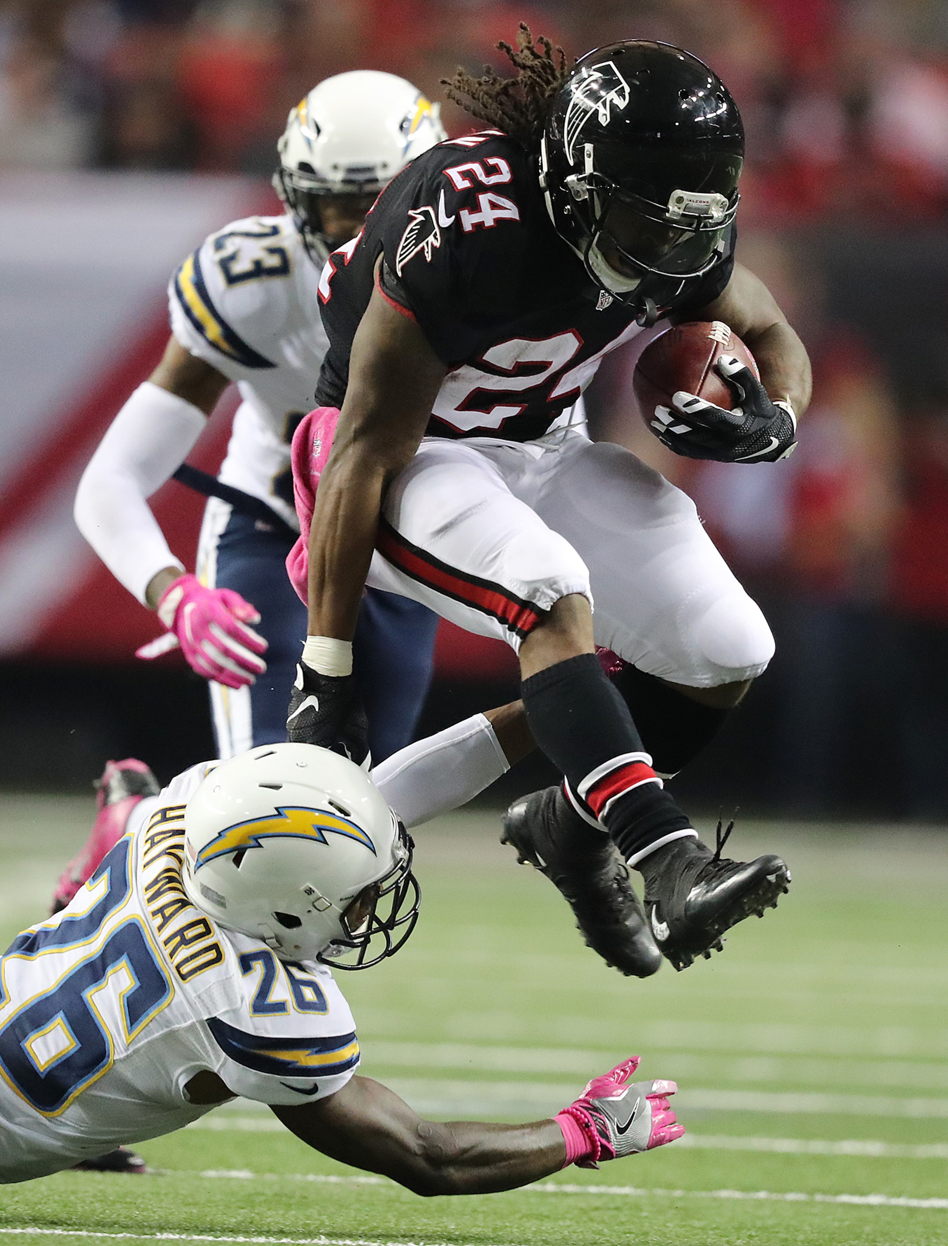 Devonta Freeman jumps for extra yardage Casey Heyward of the Chargers.