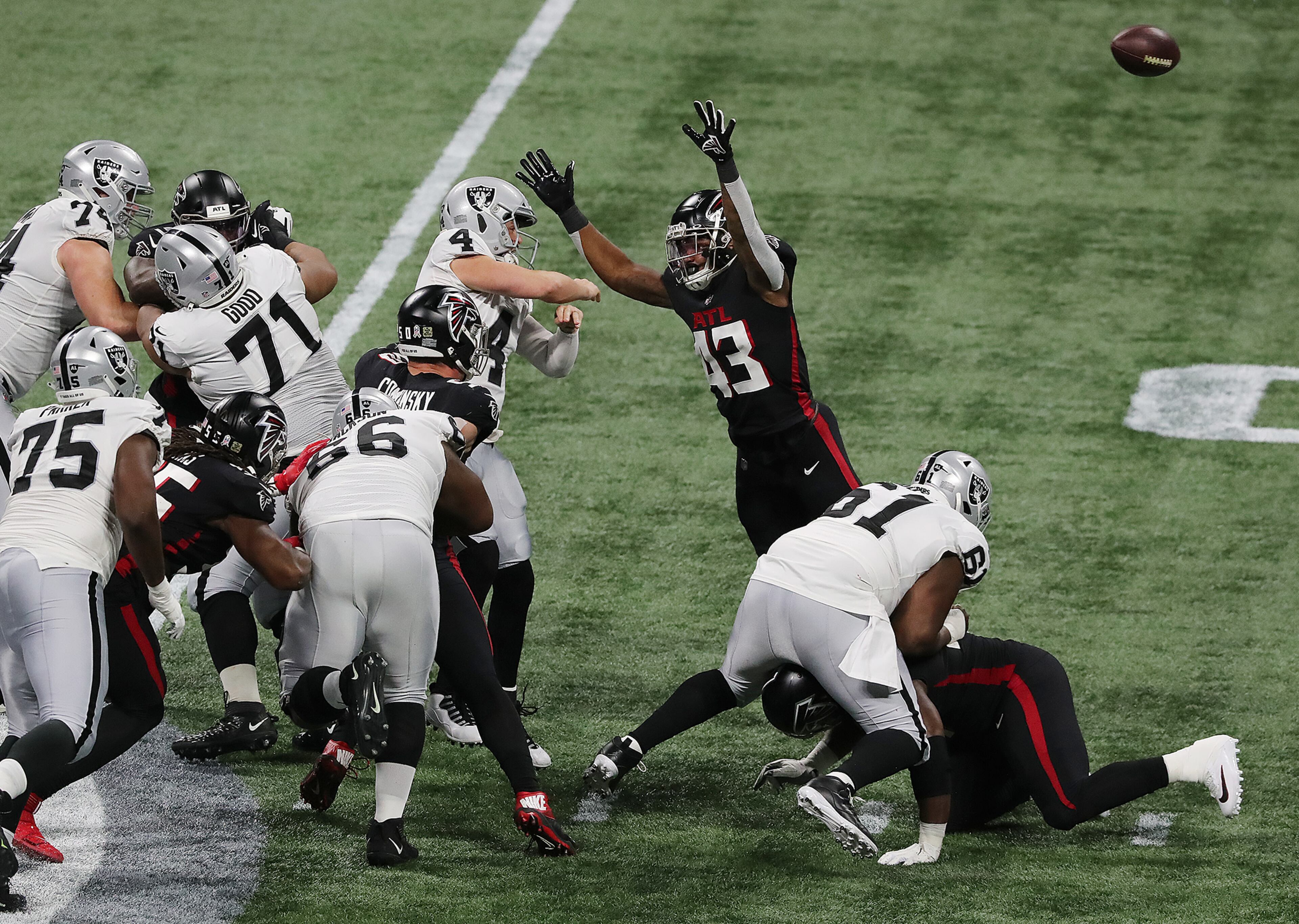 Falcons linebacker Mykal Walker (43) pressures Las Vegas Raiders quarterback Derek Carr (4) as his errant throw is intercepted during the third quarter Sunday, Nov. 29, 2020, at Mercedes-Benz Stadium in Atlanta. (Curtis Compton / Curtis.Compton@ajc.com)