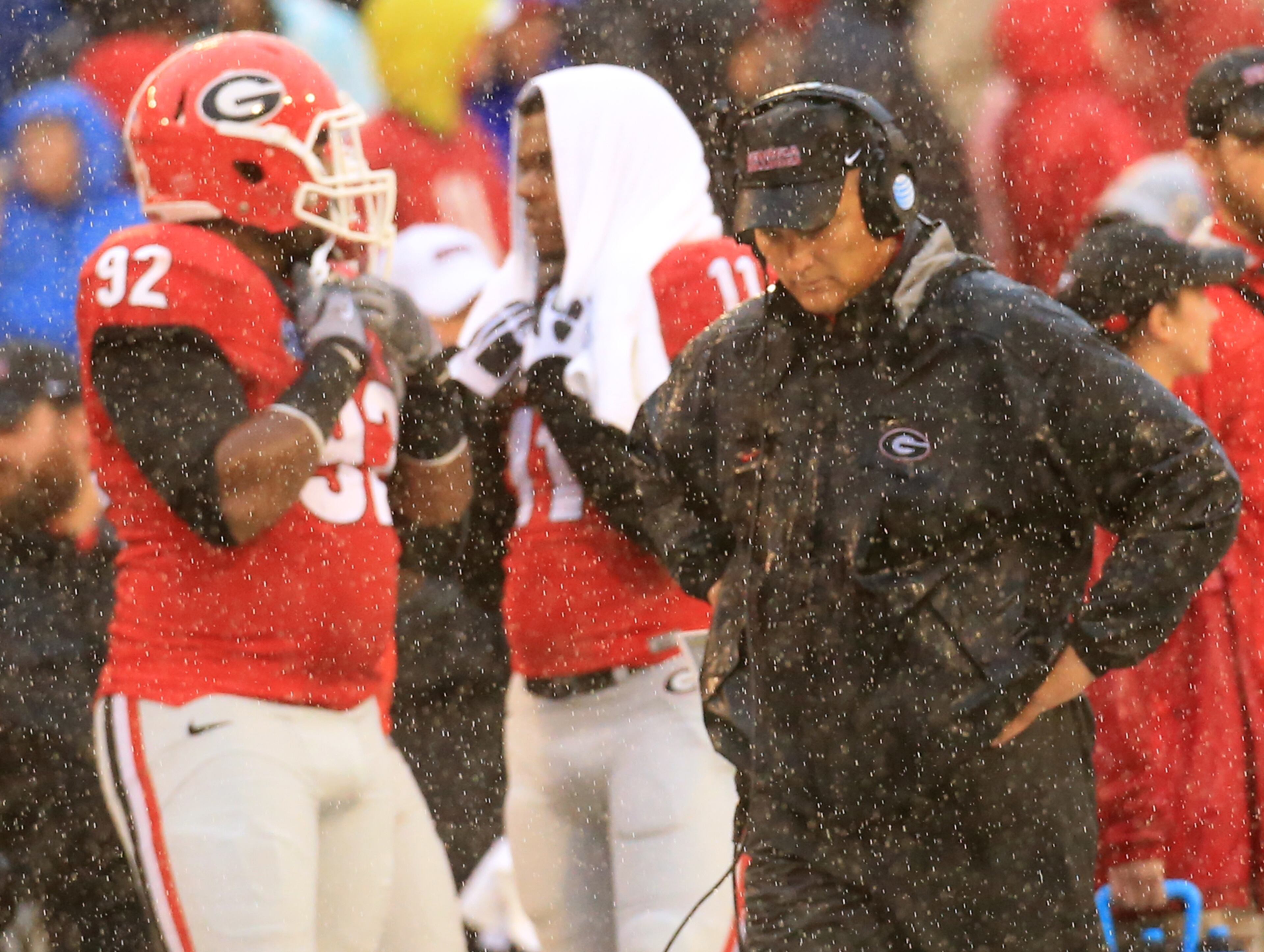 Georgia head coach Mark Richt walks the sidelines in a downpour during the second half of a 38-10 loss to Alabama on Saturday, Oct. 3, 2015, in Athens. Curtis Compton / ccompton@ajc.com