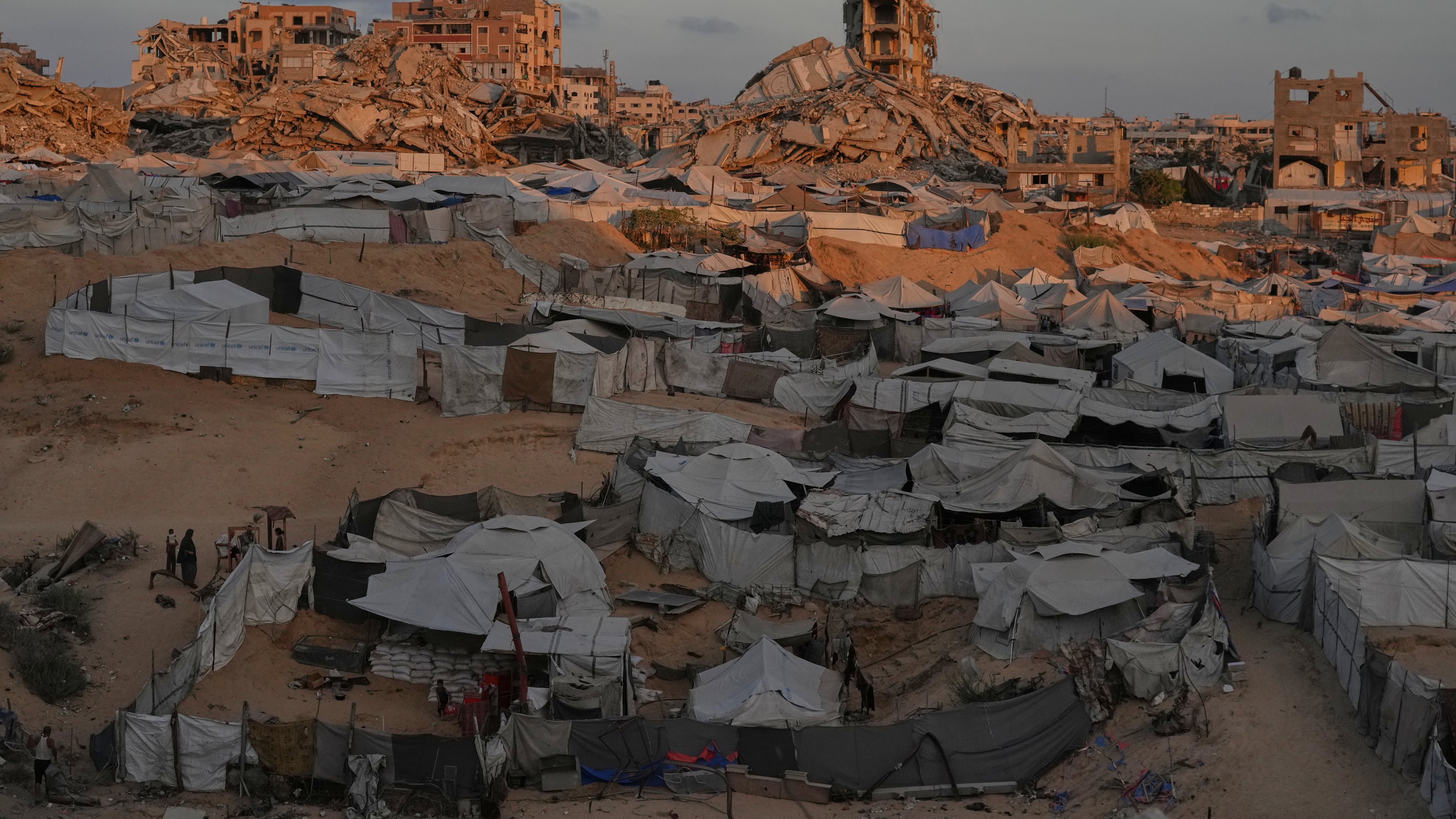 Tents sheltering displaced Palestinians are seen amid war-damaged buildings in Gaza City, Saturday, Sept. 26, 2026. (AP Photo/Jehad Alshrafi)