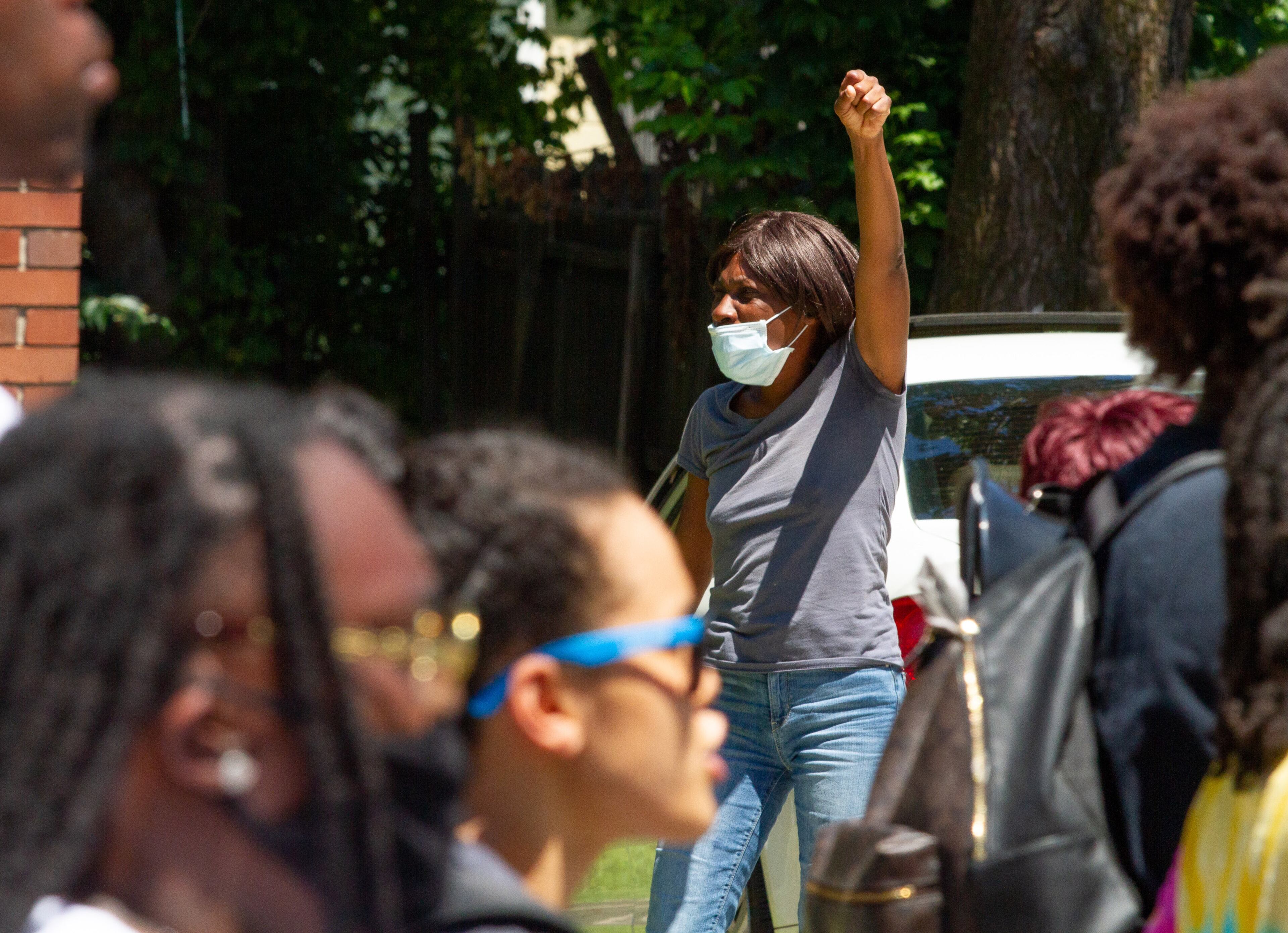 A spectator along Rockwell Street cheers on the marchers as they head for the Wendy's on University Avenue during the 'Take Back the Wendy's' March & Rally in Atlanta on Saturday, July 11, 2020. The march started at the Community Movement Builders community house and ended at the Wendy's. STEVE SCHAEFER FOR THE ATLANTA JOURNAL-CONSTITUTION