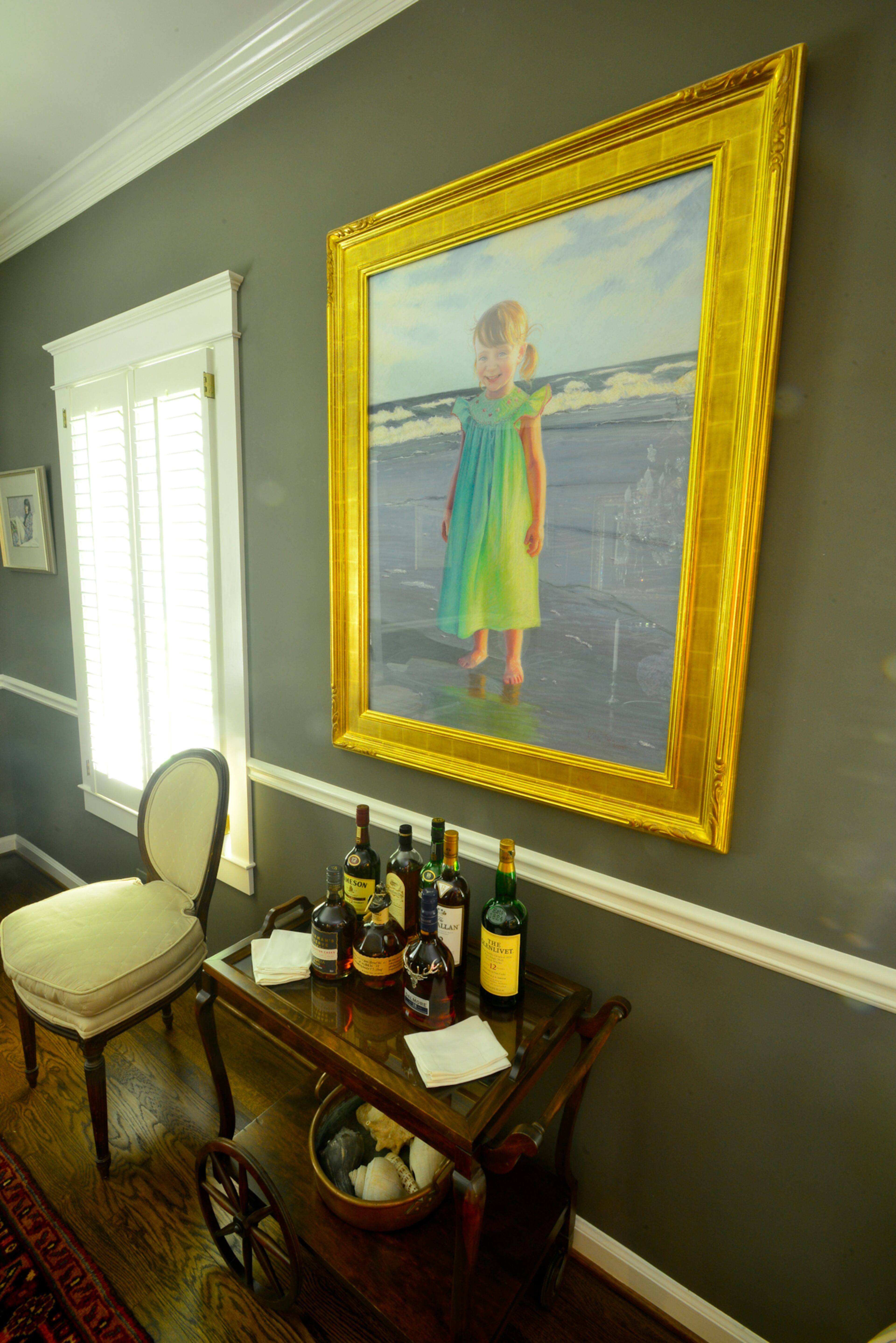 The generations are represented in the dining room, with a tea cart that belonged to Lisa Gleim-Jonas' great-grandmother and a portrait she painted of daughter Libby as a 2 year old. The dining room walls are painted Sherwin-Williams' Porpoise.