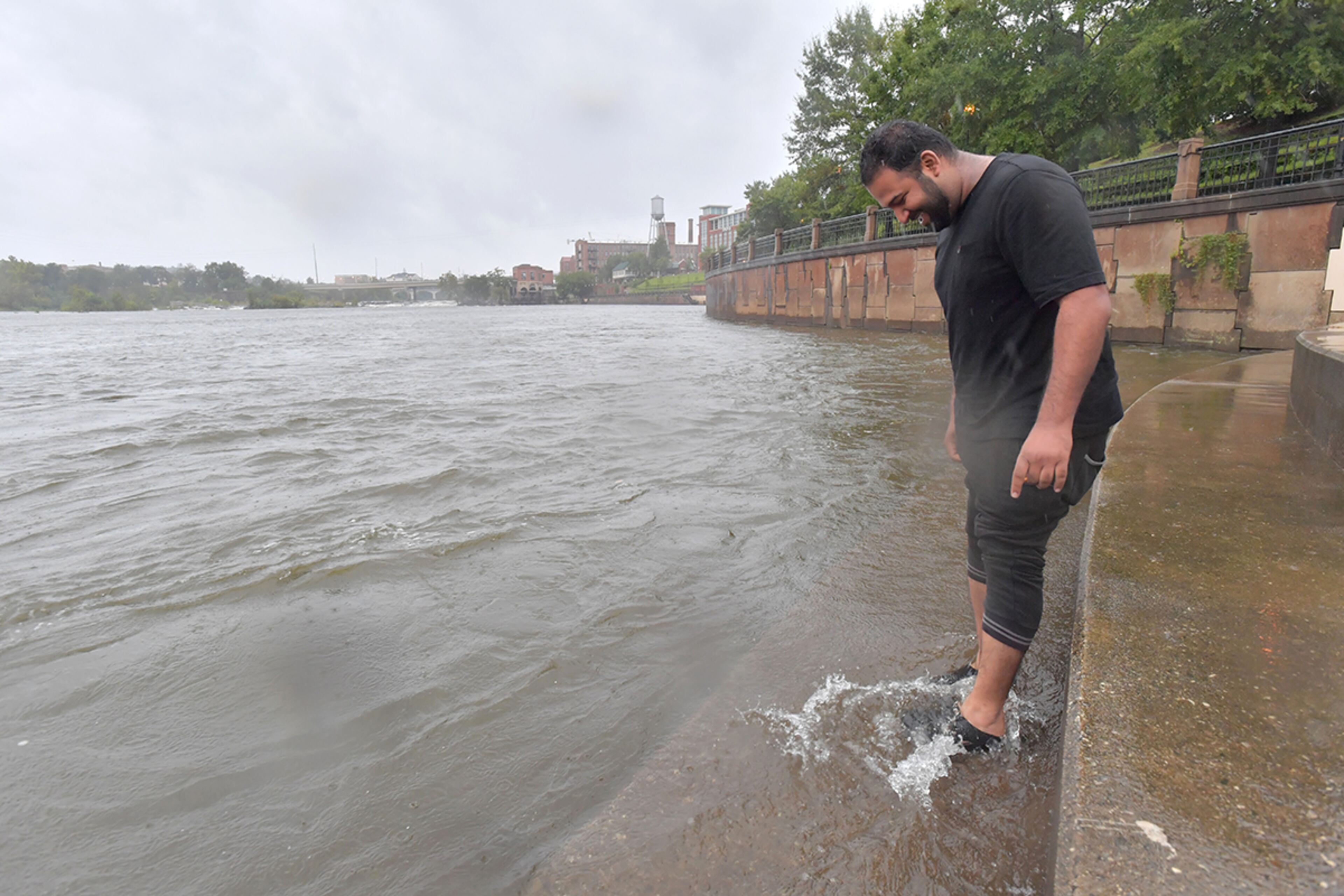 September 11, 2017 Columbus - Munib Riaz, student at Columbus State University, checks out rising water near the school campus in uptown Columbus ahead of Hurricane Irma on Monday, September 11, 2017. The Georgia coast was hit hard Monday morning, with pounding rains, roaring winds and storm surge. More than 87,000 Georgia Power customers were without power in the Savannah area, as were another 96,000 from Brunswick and St. Simons south to St. Marys, at the Florida line. HYOSUB SHIN / HSHIN@AJC.COM
