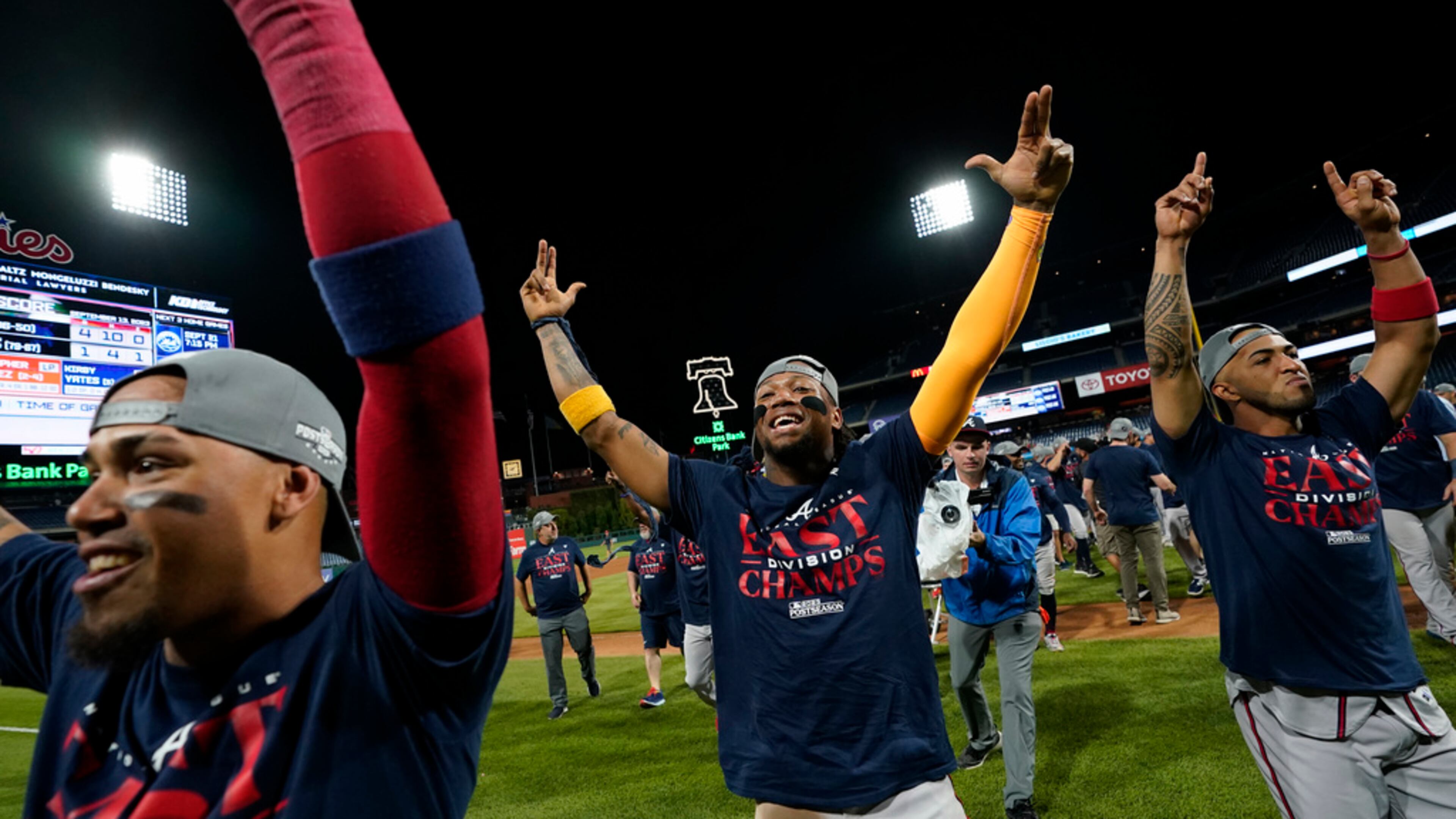 Atlanta Braves' Orlando Arcia, from left, Ronald Acuna Jr. and Eddie Rosario celebrate after clinching their sixth consecutive NL East title by defeating the Philadelphia Phillies in a baseball game, Wednesday, Sept. 13, 2023, in Philadelphia. (AP Photo/Matt Slocum)