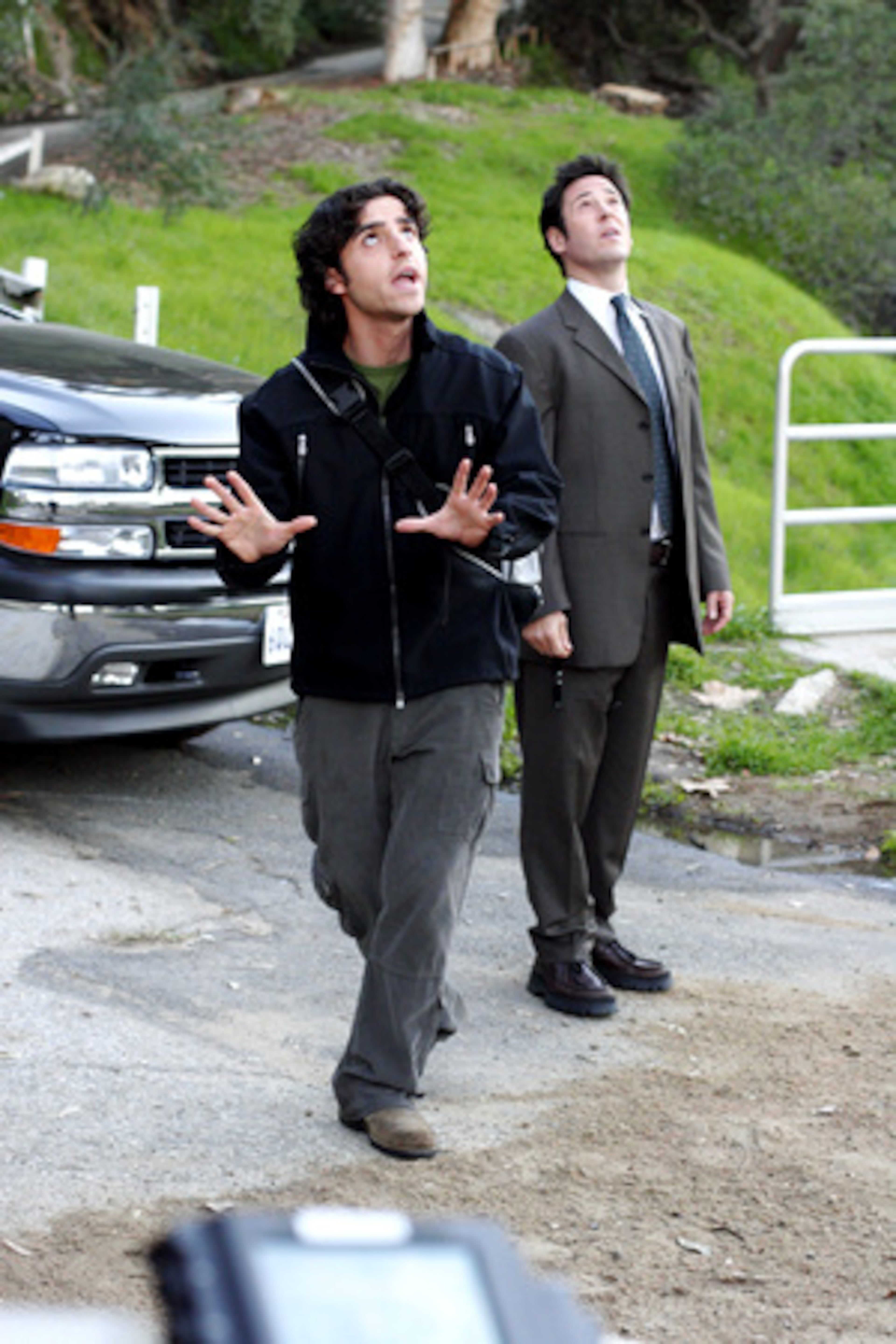 Tousled math professor Charlie Eppes (David Krumholtz, foreground, with Rob Morrow) solves murders with equations in "NUMB3RS."