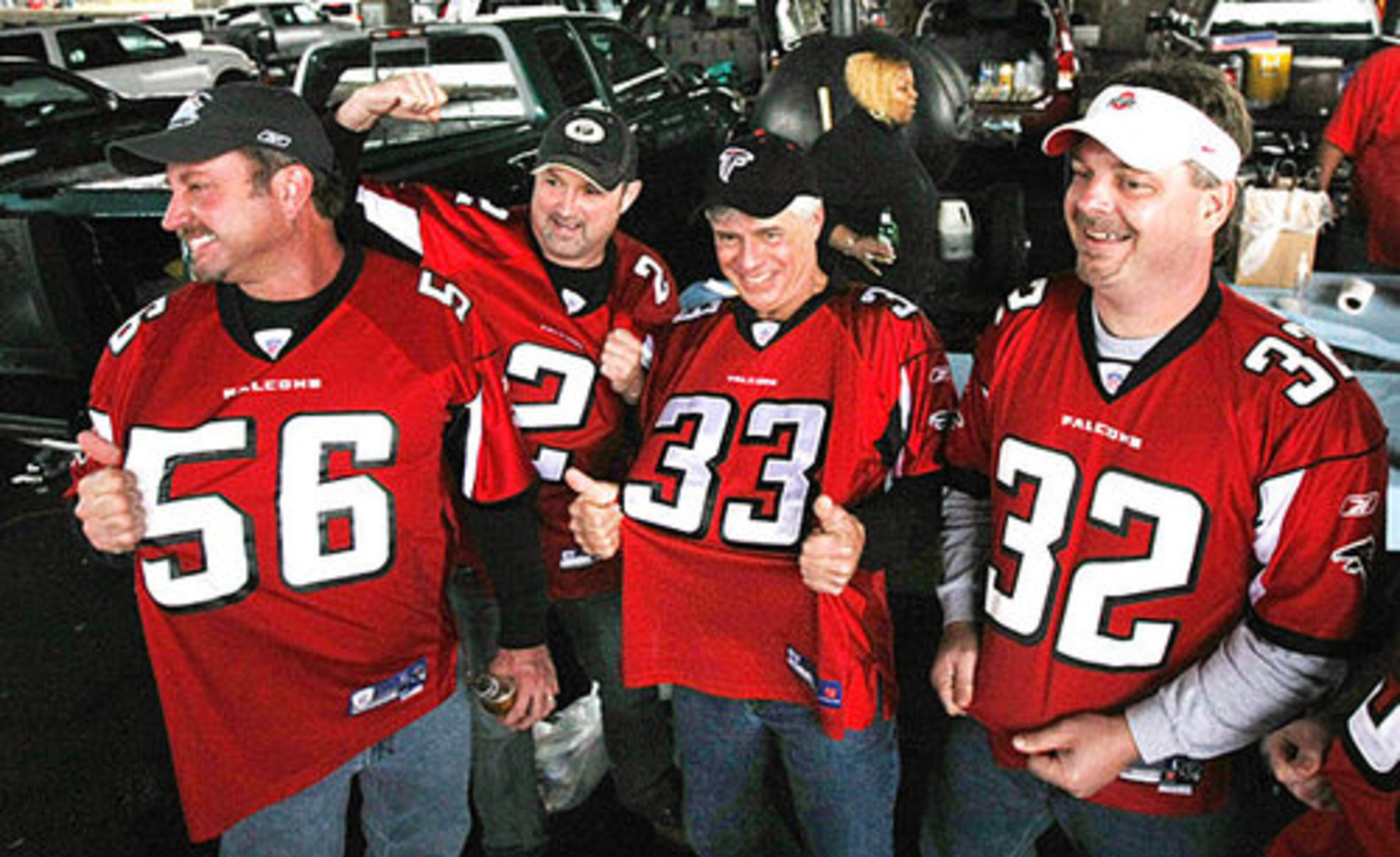 Sporting Falcons jerseys, from left to right, David Bruce, Keith Sumner, Jeff Brookshire, and Carl Zigler tailgate outside the Georgia Dome.