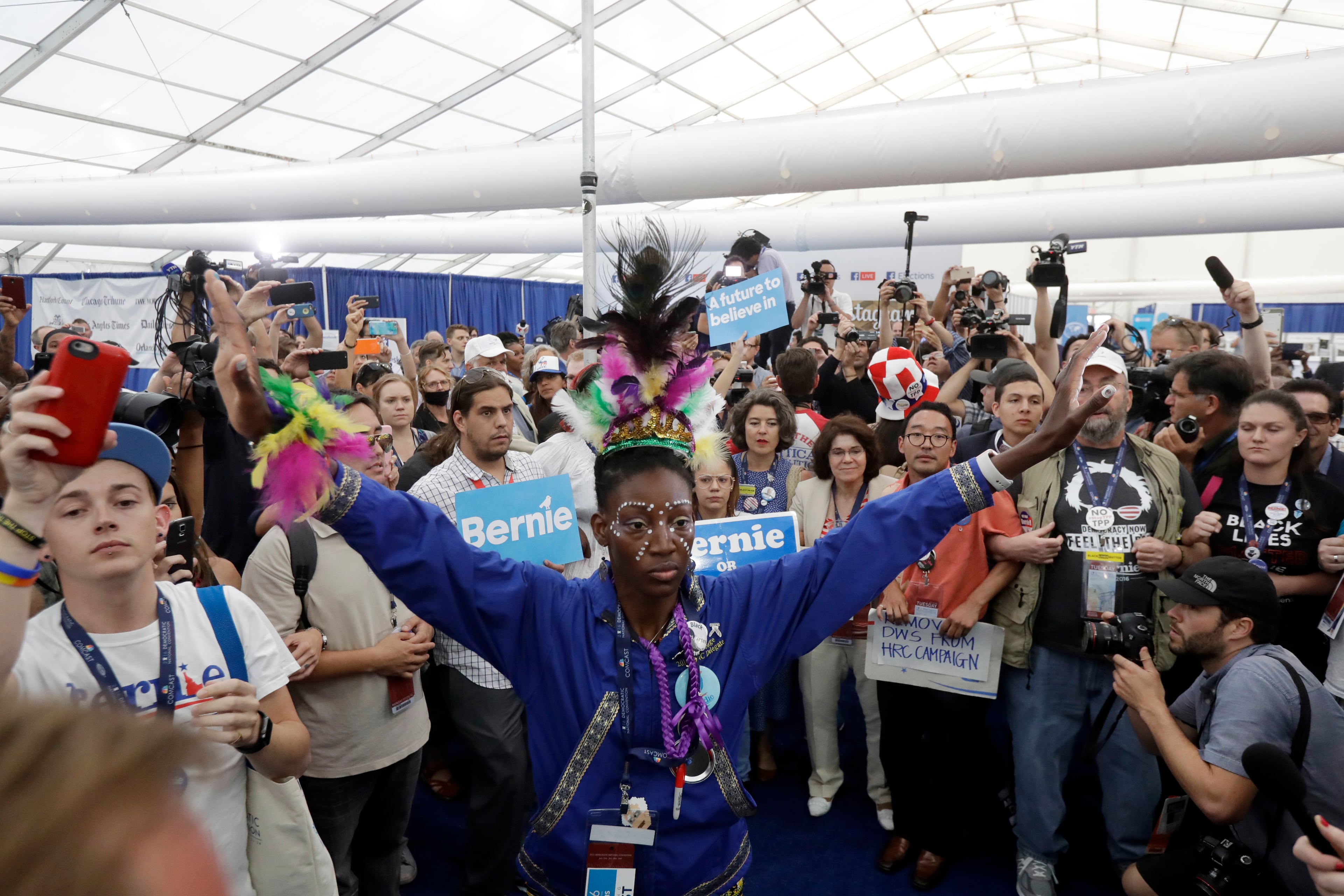 Delegates walk out of the convention as they protest in the media filing center during the second day session of the Democratic National Convention in Philadelphia, Tuesday, July 26, 2016. (AP Photo/Matt Rourke)