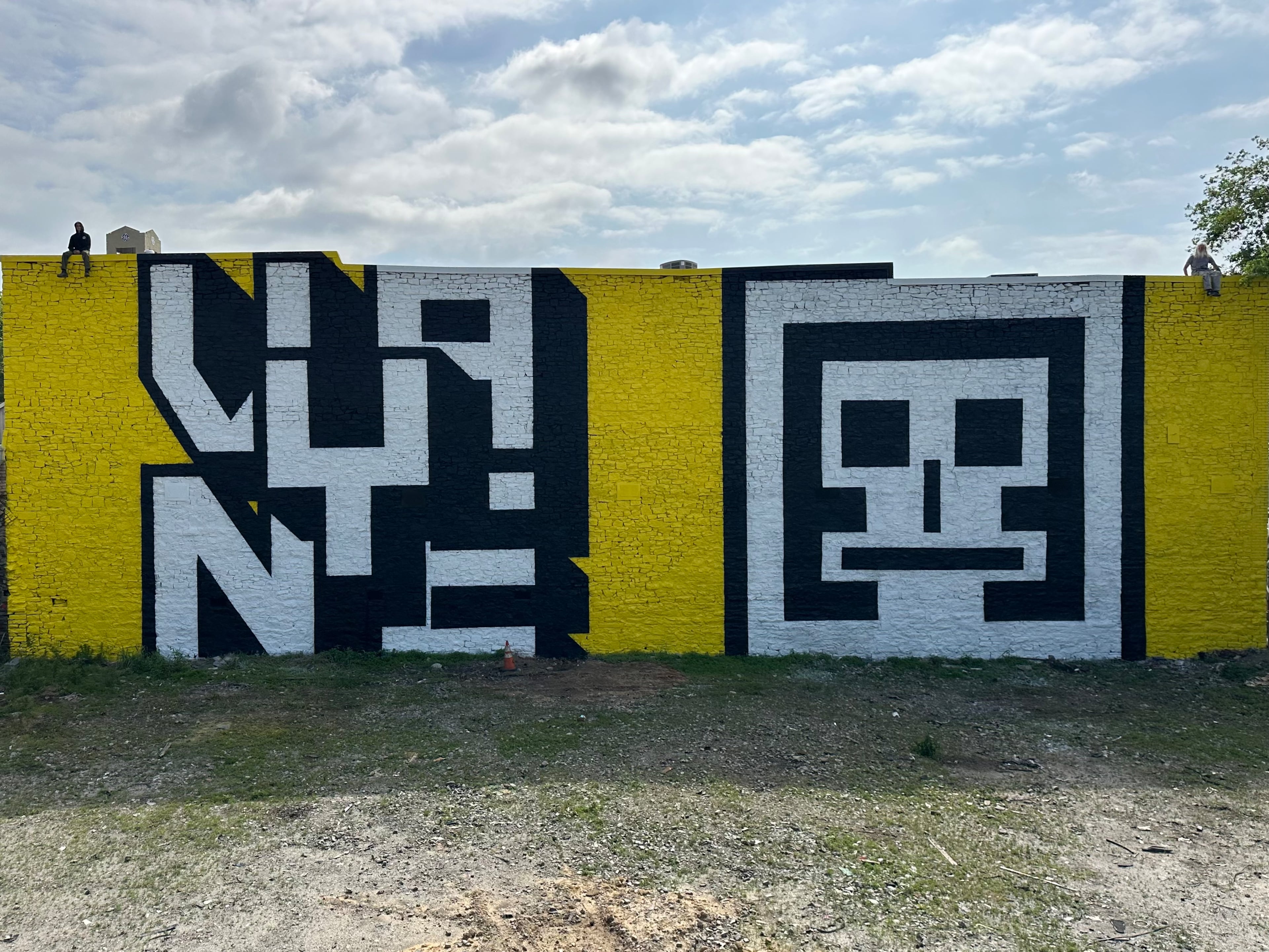 The Art Share Foundation commissioned this mural by Atlanta artists Vayne and Evereman on the back of the Eyedrum art and music gallery at 515 Ralph David Abernathy Blvd. SW (at Humphries Street). The artists are shown sitting on the wall above their respective works. (Courtesy of The Art Share Foundation)