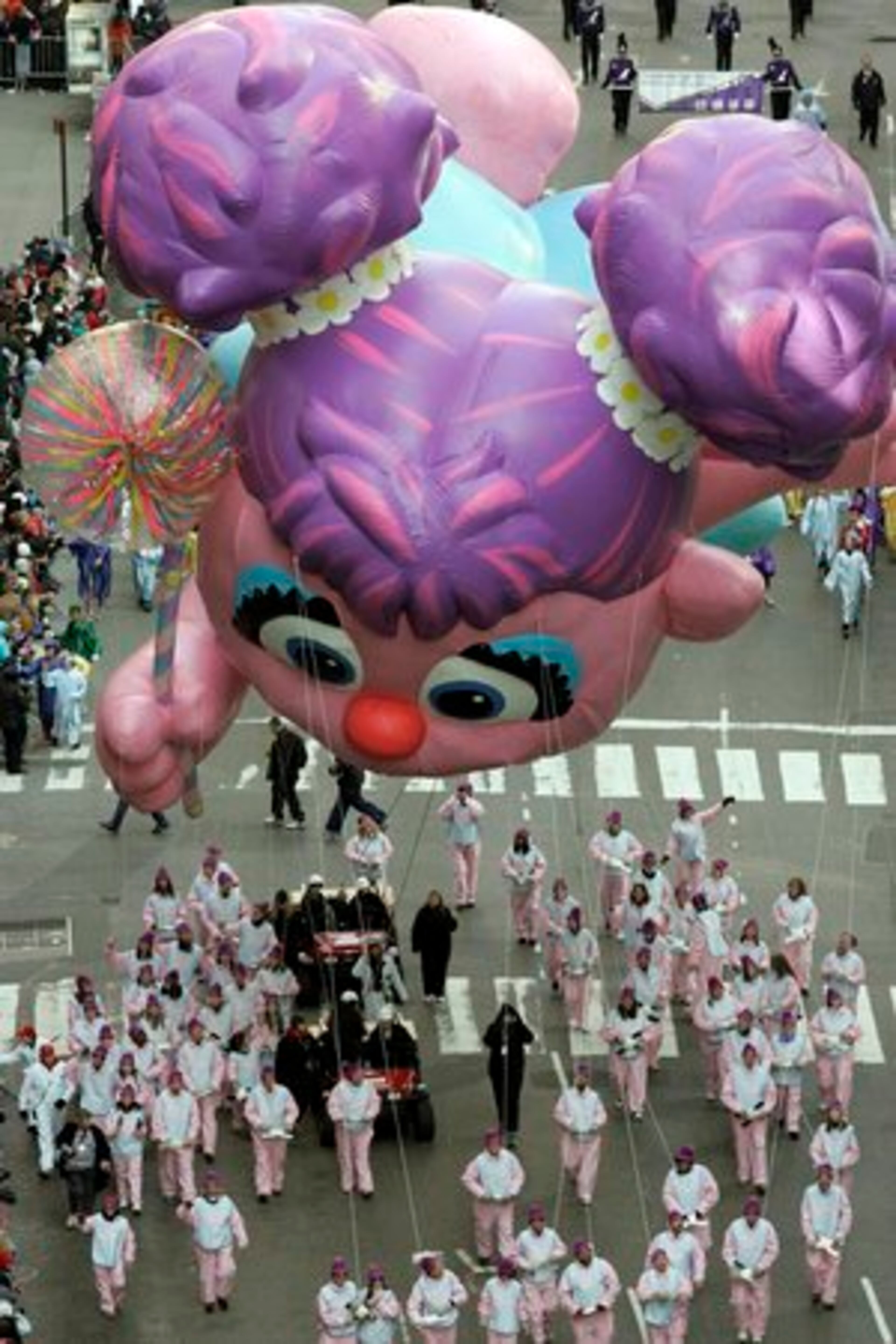 An Abby Cadabby float hovers above its handlers.