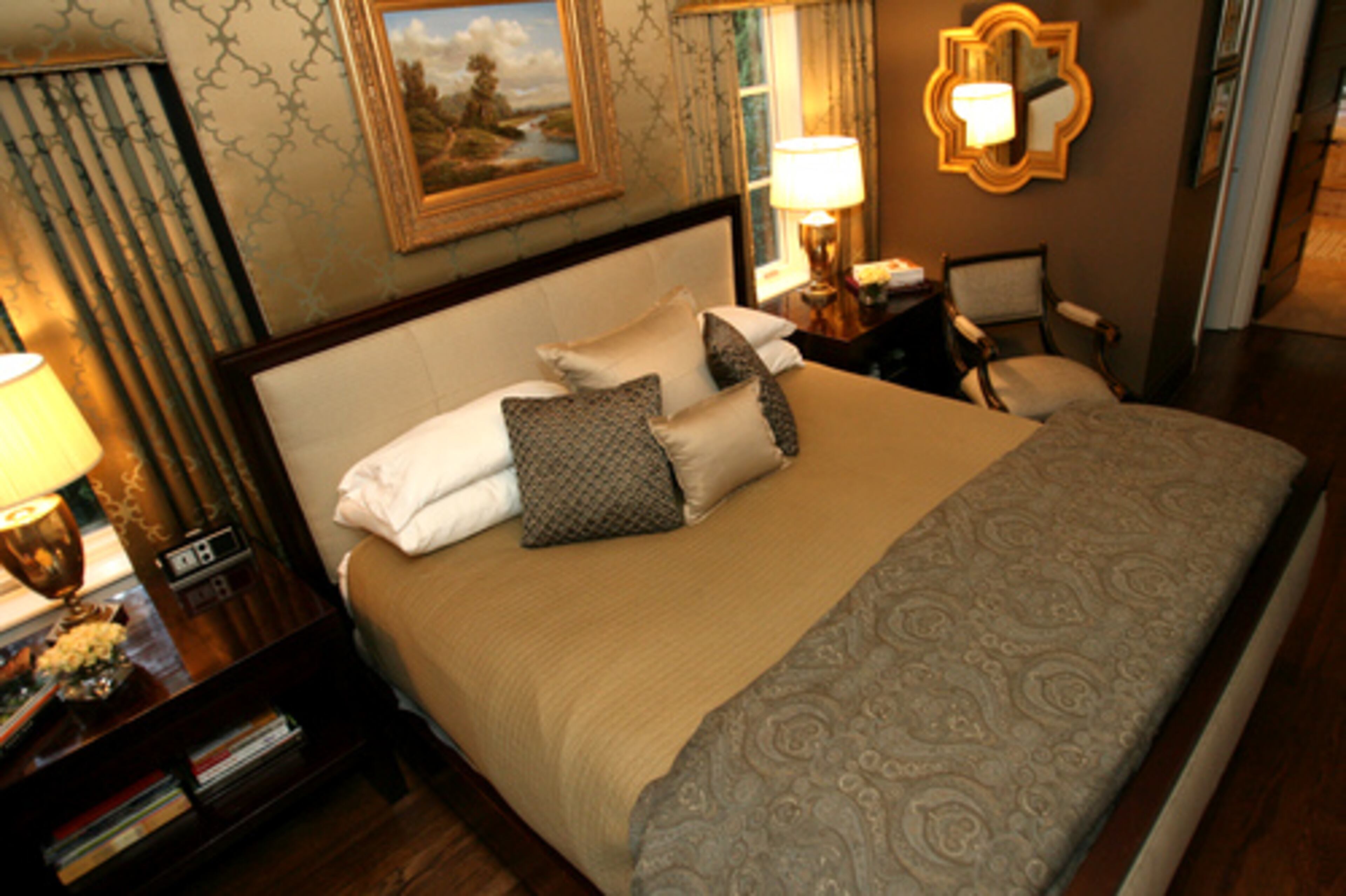 A fireplace is hidden behind the headboard in the master bedroom. There are four fireplaces in the home, but none are used.