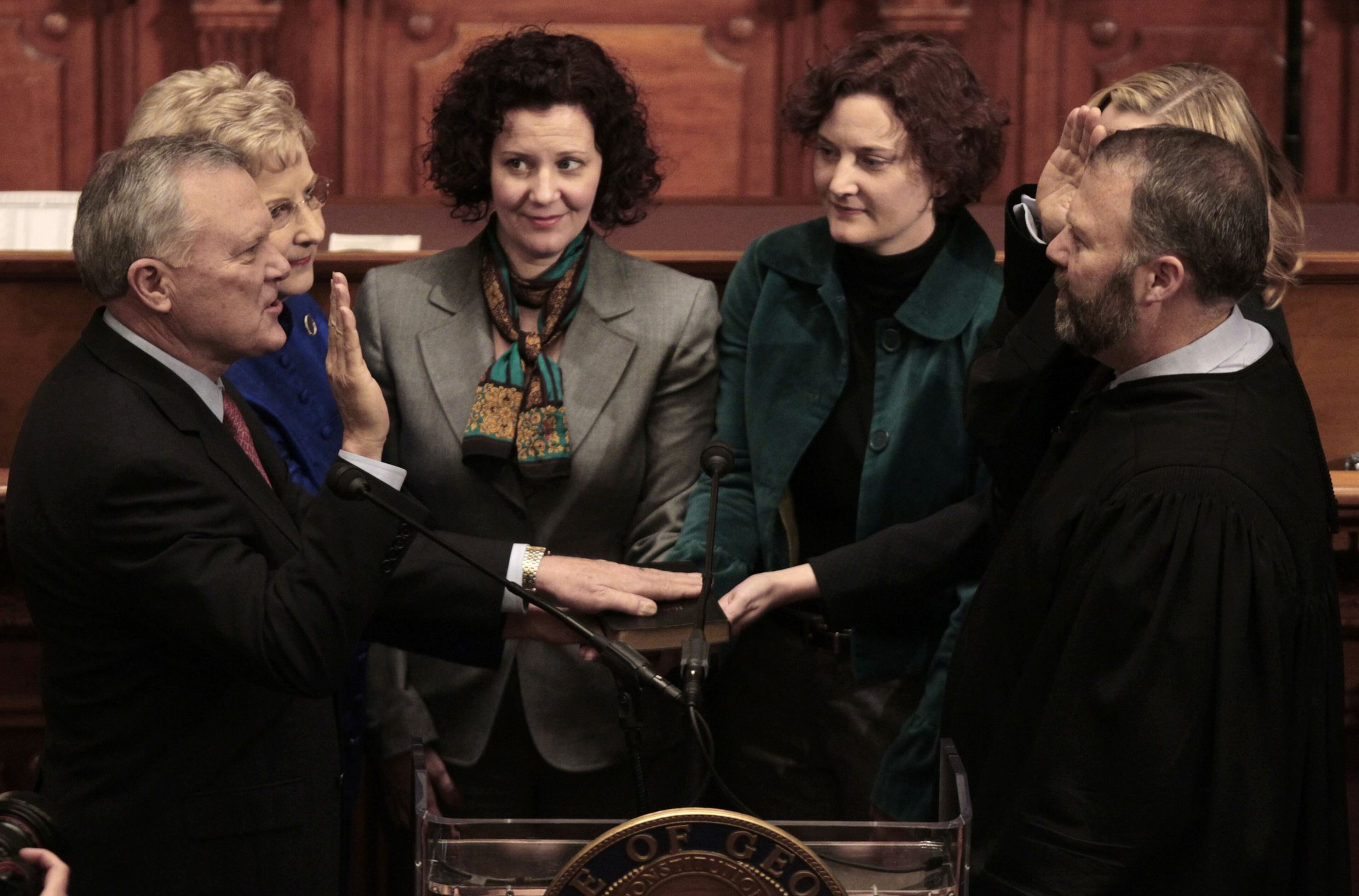 Nathan Deal (left) is sworn in as the 82nd governor of Georgia by his son, Hall County Superior Court Judge Jason Deal, in the House chamber on January 10, 2011, in Atlanta.